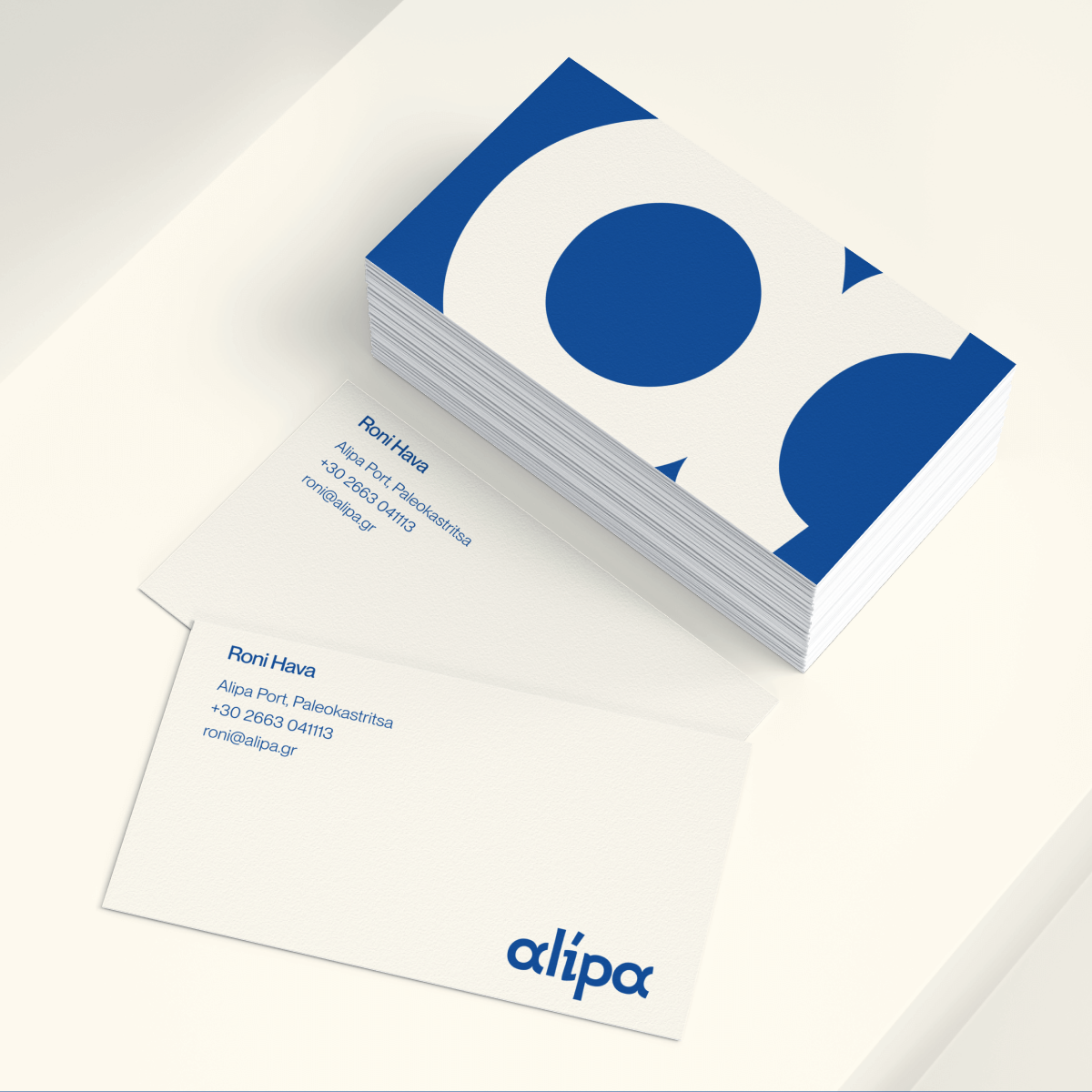 Alipa business cards showing the logo and brand colors.