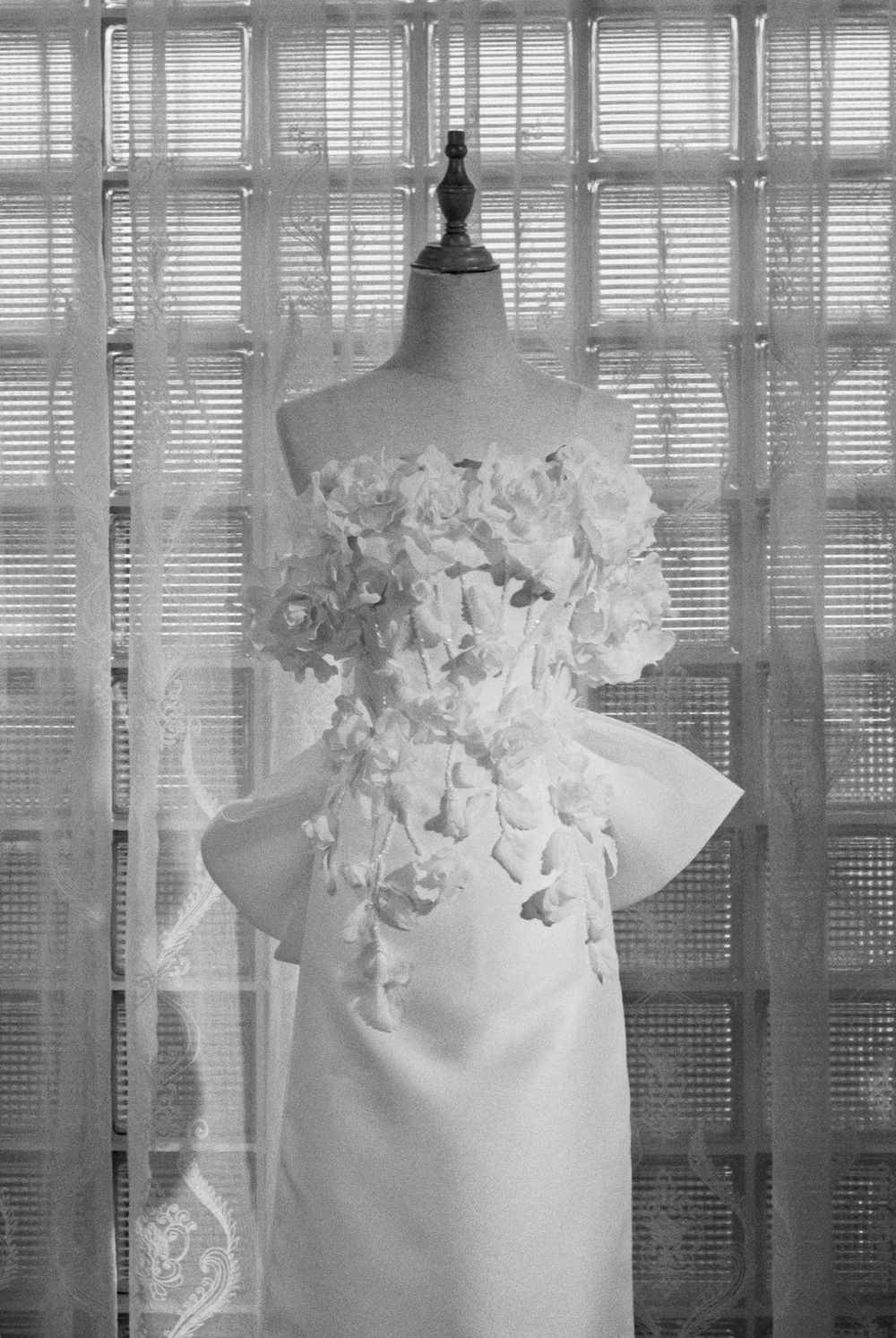 A bridal gown on a mannequin in the atelier