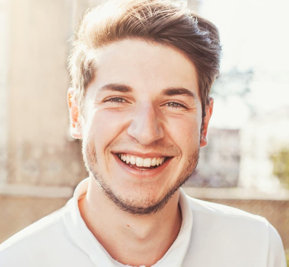 smiling young man in white shirt