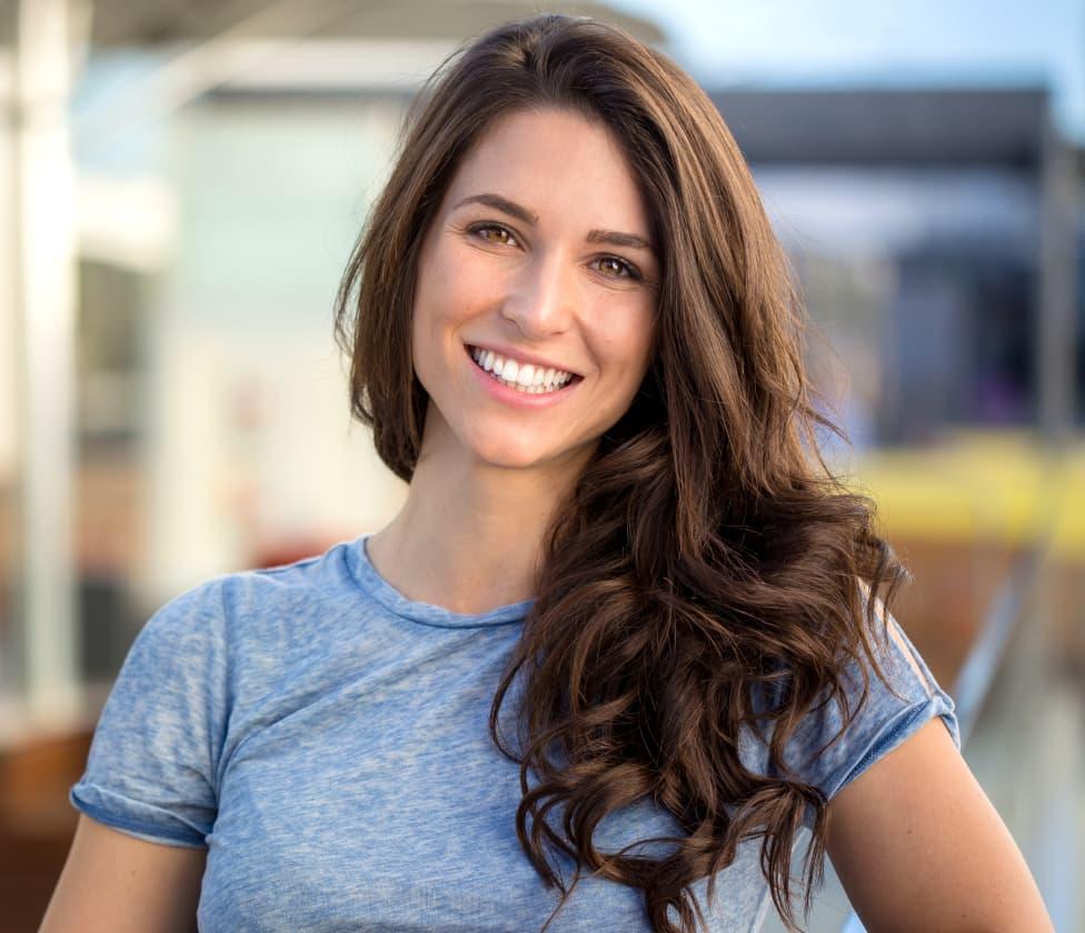 lady in blue shirt smiling at the camera