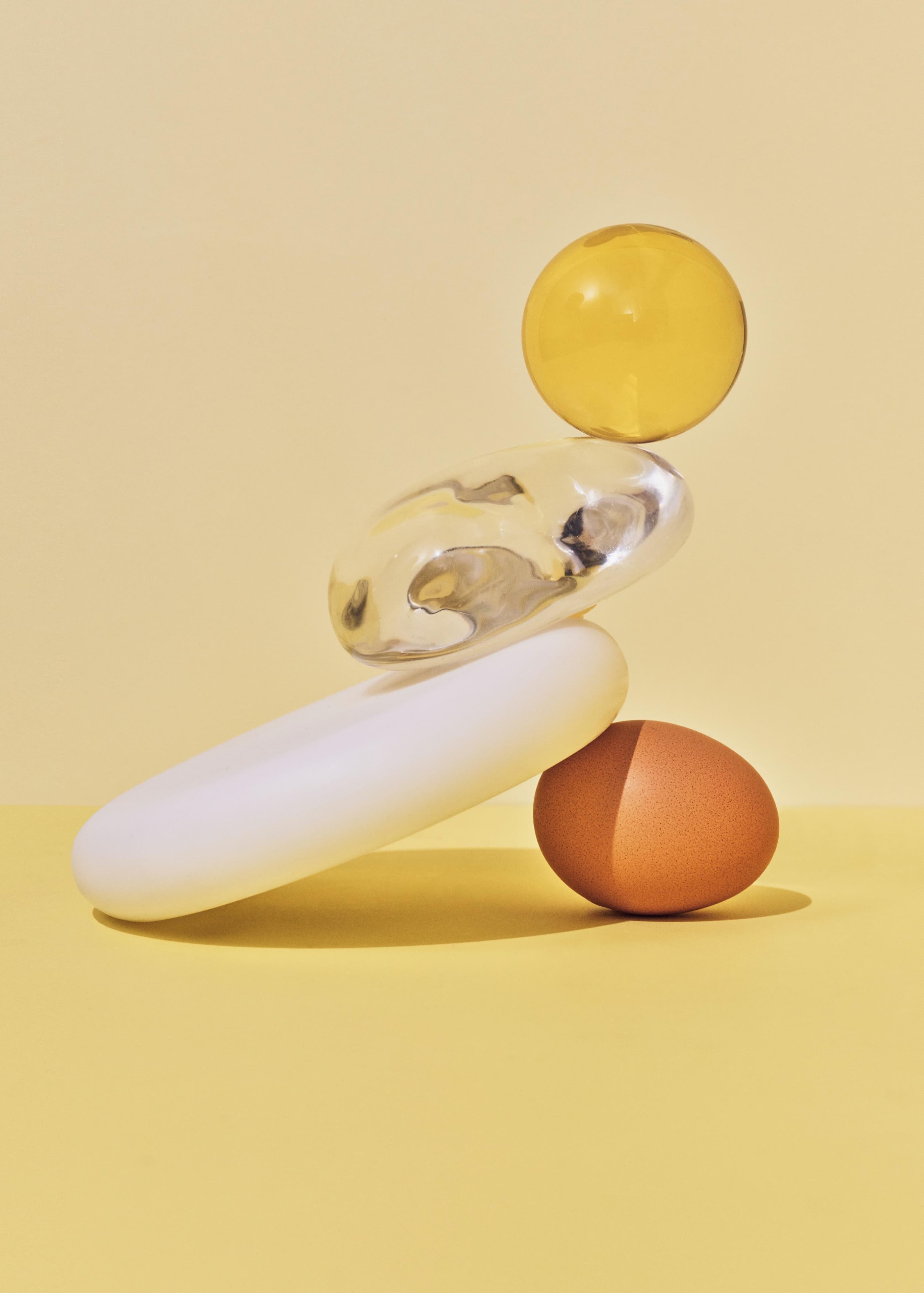 Egg balancing with glass and ceramics pieces, at bottom, not cracking