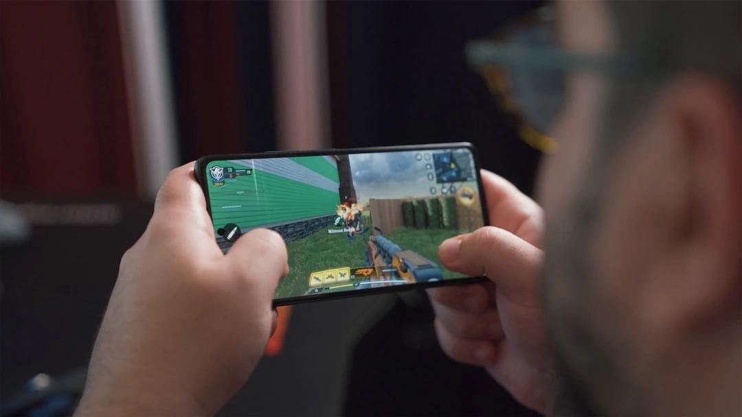 person playing mobile game on android phone - best google play paid games
