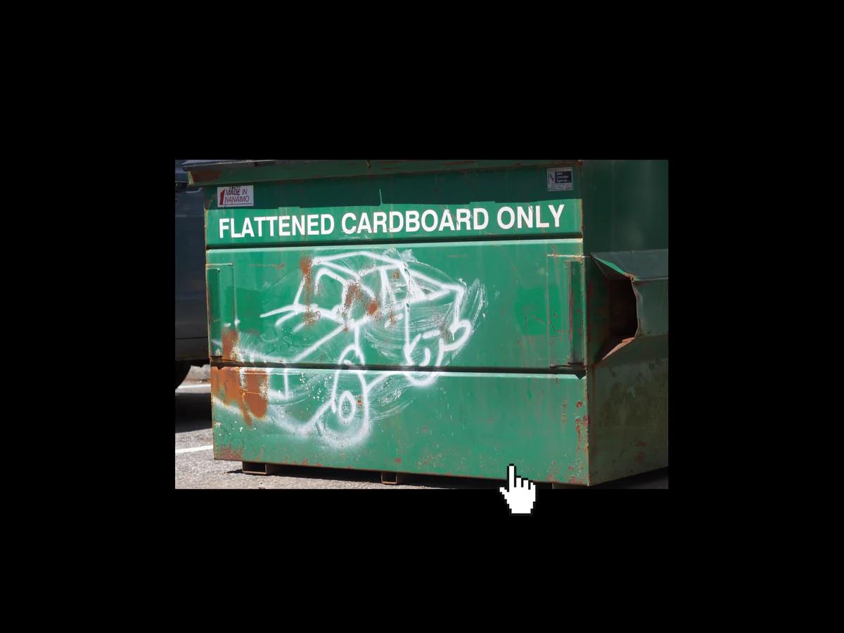 Green dumpster, with spray painted white car on the front and a white serif all caps text, reading "flattened cardboard only"