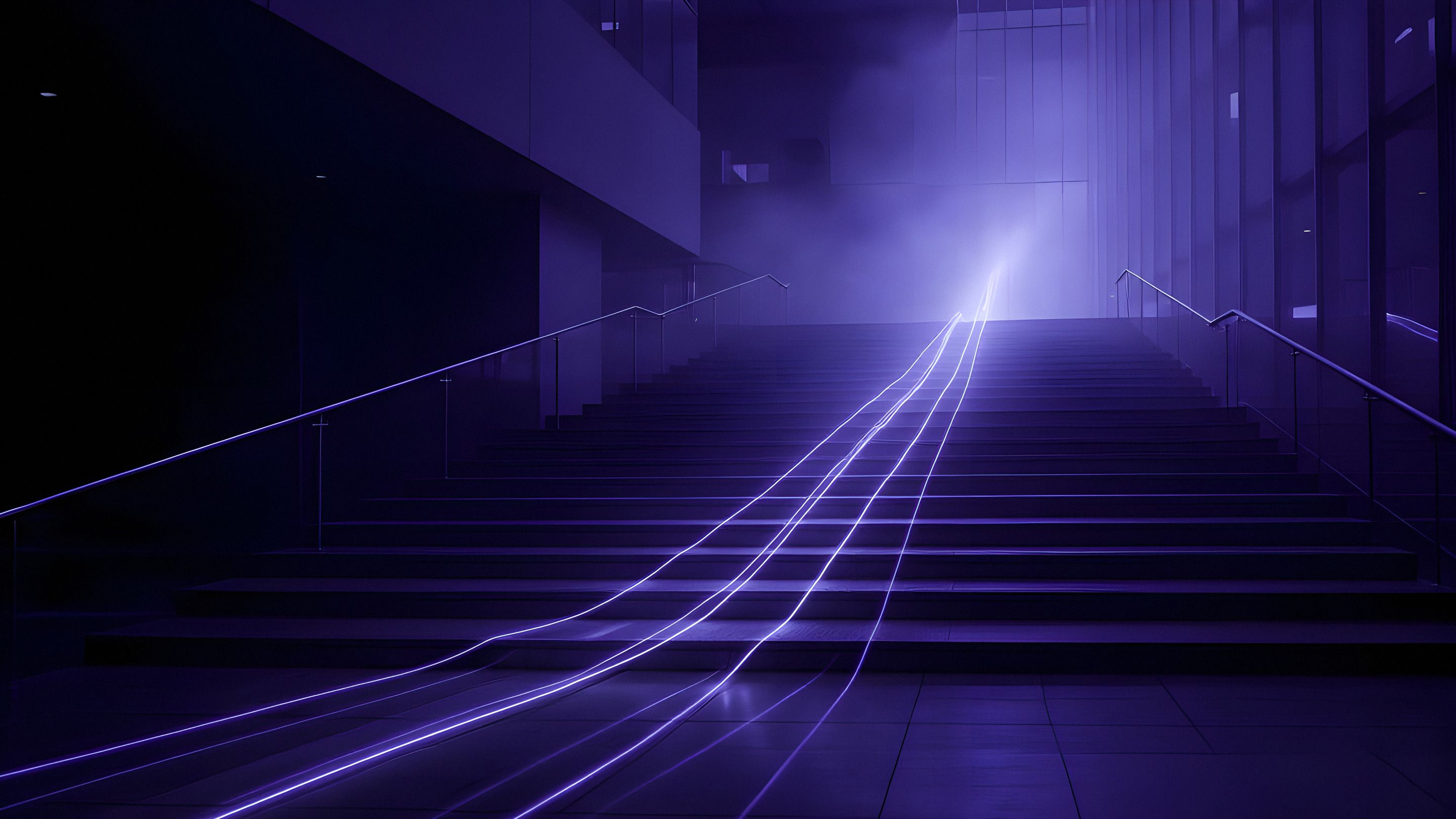 Lines of light rising up a wide flight of stairs in a dark atrium