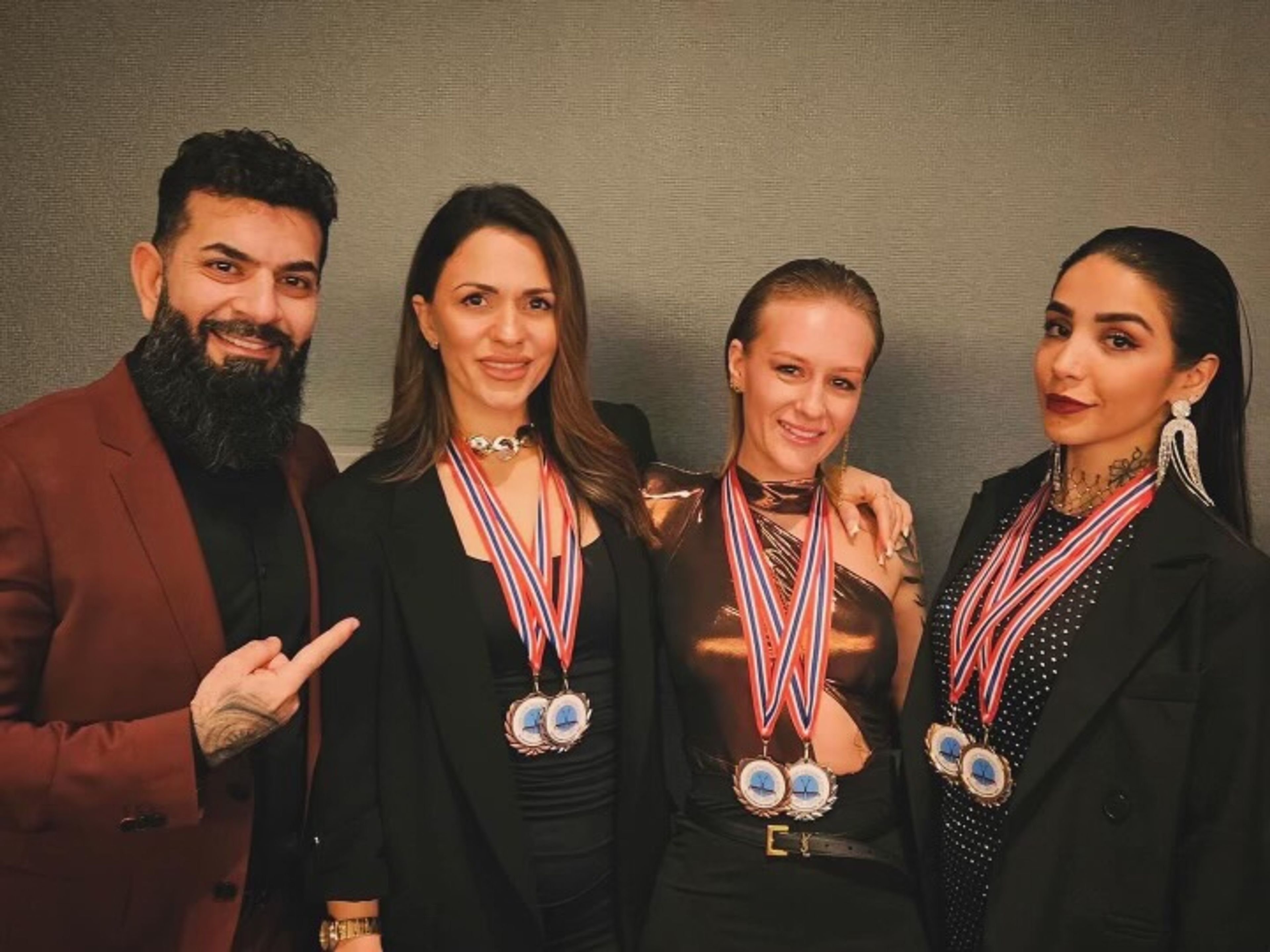 Bilder av 4 ansatte med medaljer rundt halsen