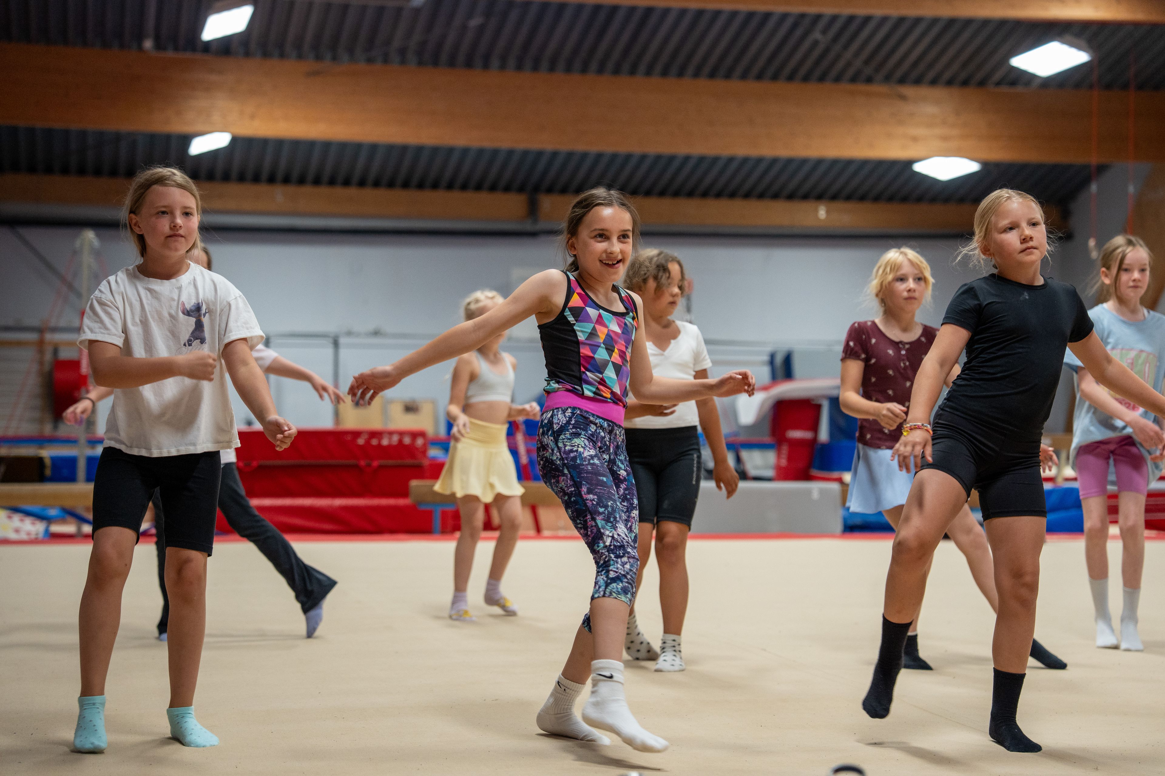 Nisa og de andre barna danser på rekke og rad