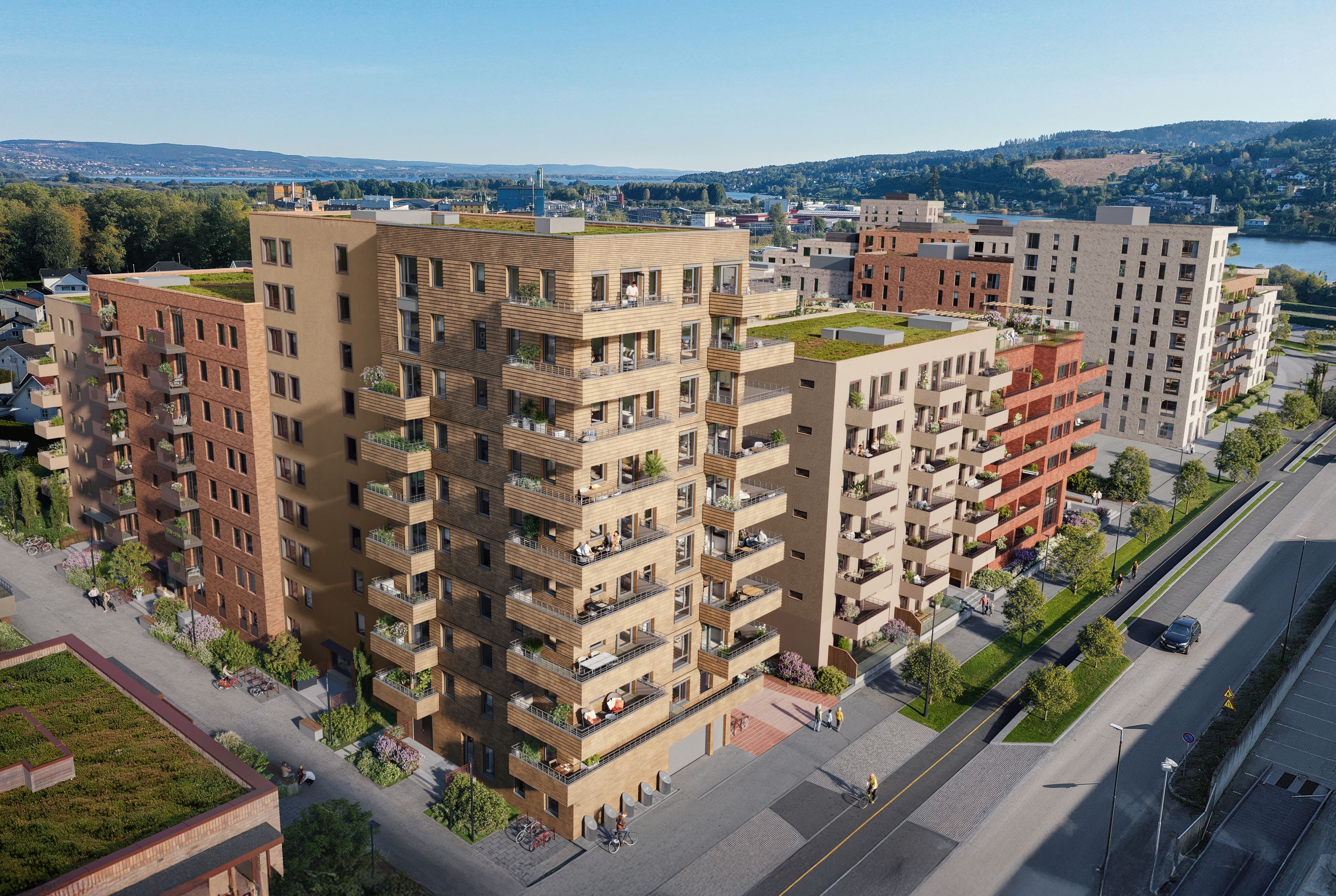 Oversiktsbilde med illustrasjon av boligprosjektet med fasader og balkonger, og området rundt Lillestrøm i bakgrunnen.