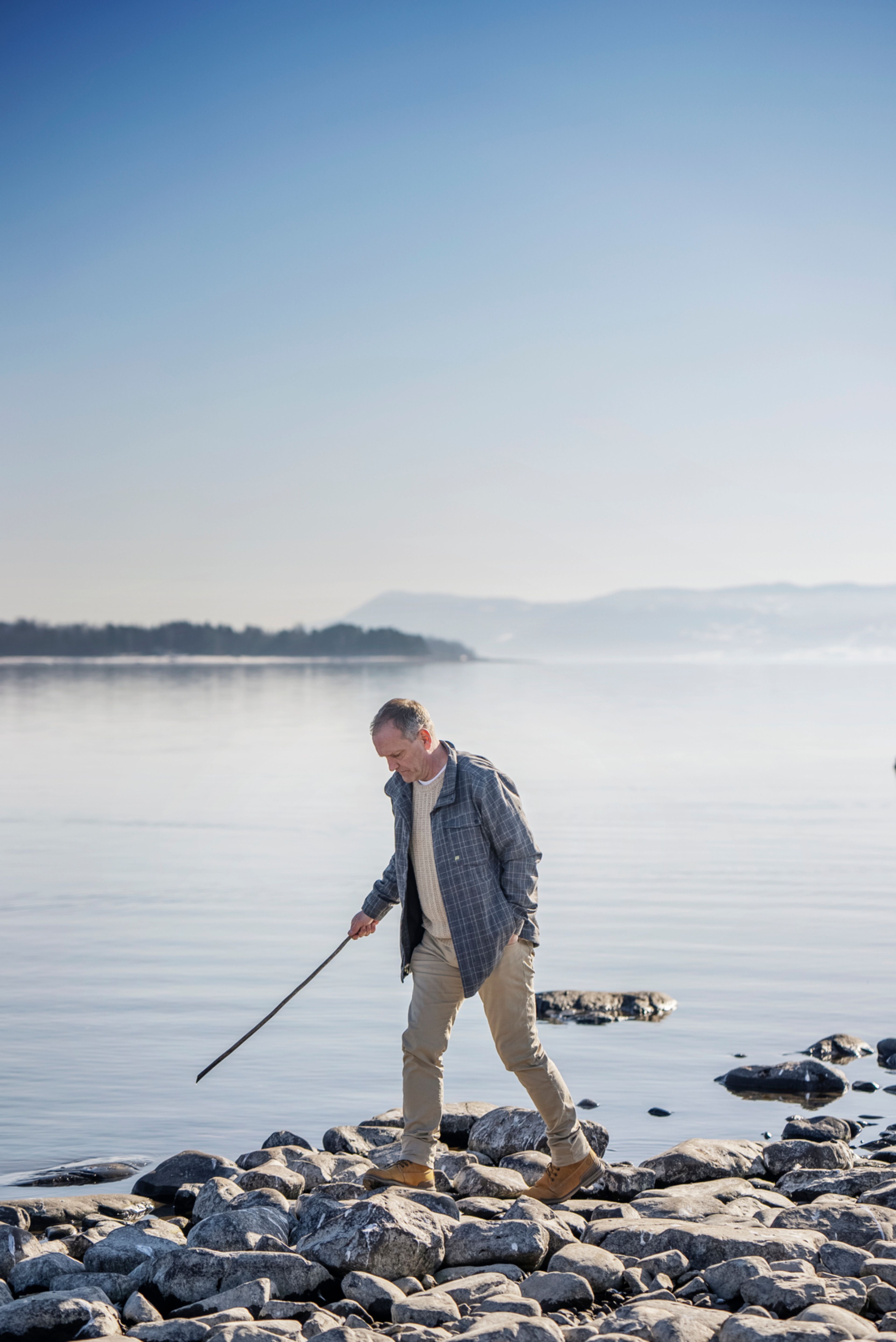Remo Martinesen går på steiner ved Mjøsa