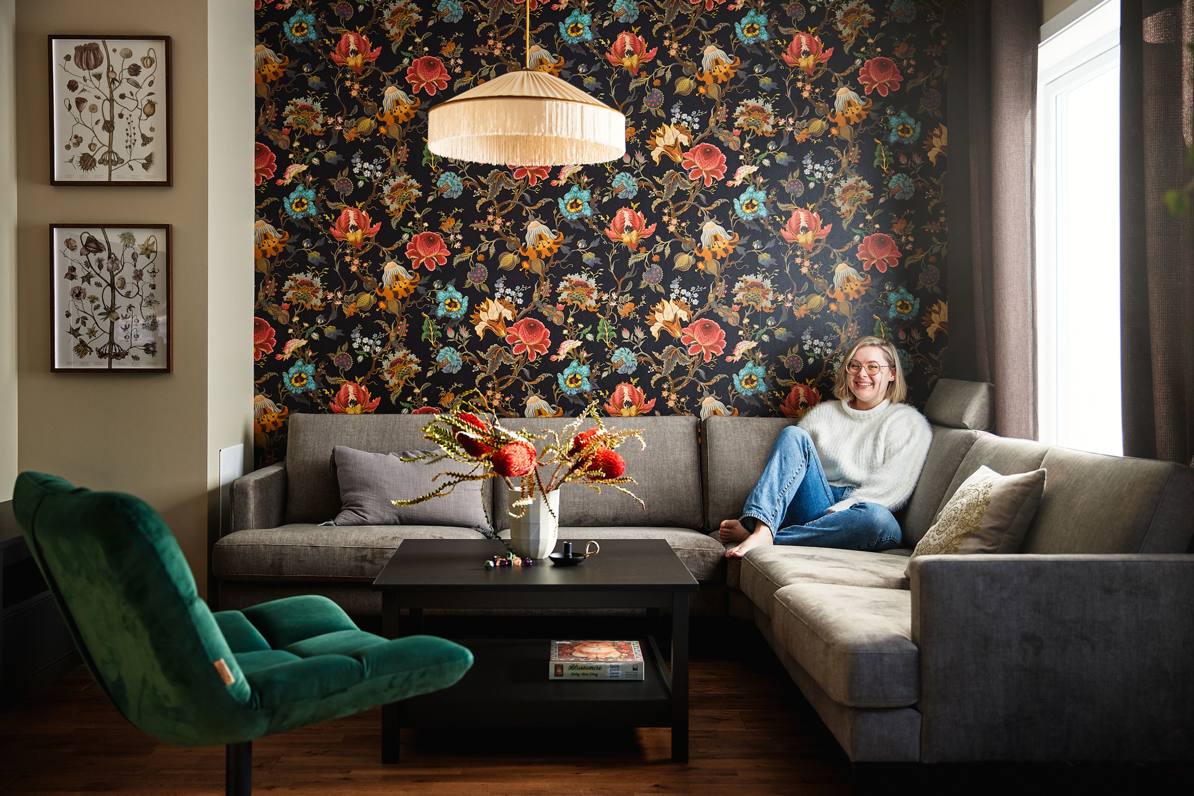 Foto av Kristine sittende i sofaen i OBOS Block Watne-leiligheten sin på Firenga på Vear