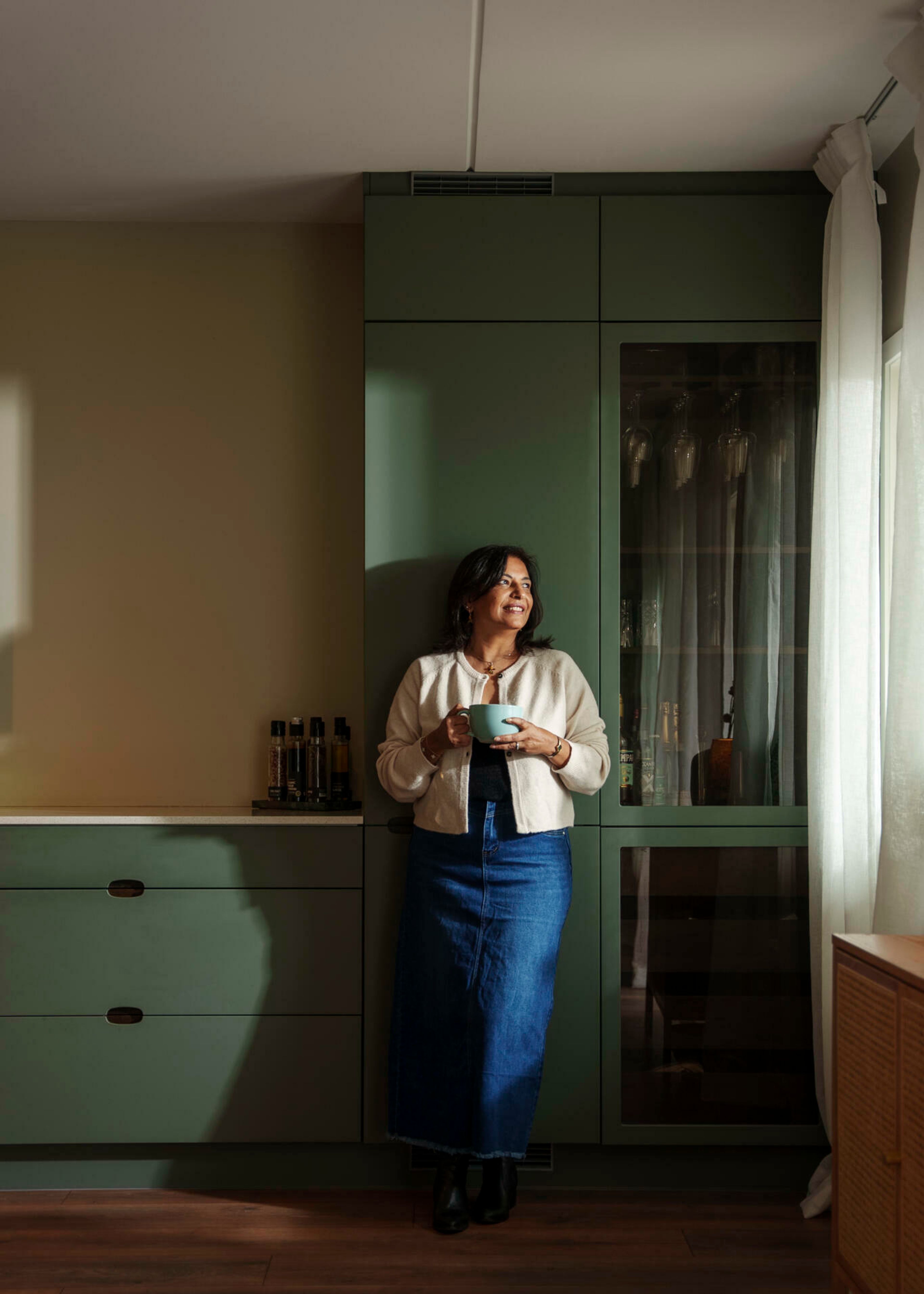 Kashmira lener seg på kjøkkenet sitt i leiligheten og nyter utsikten over Mortensrud.