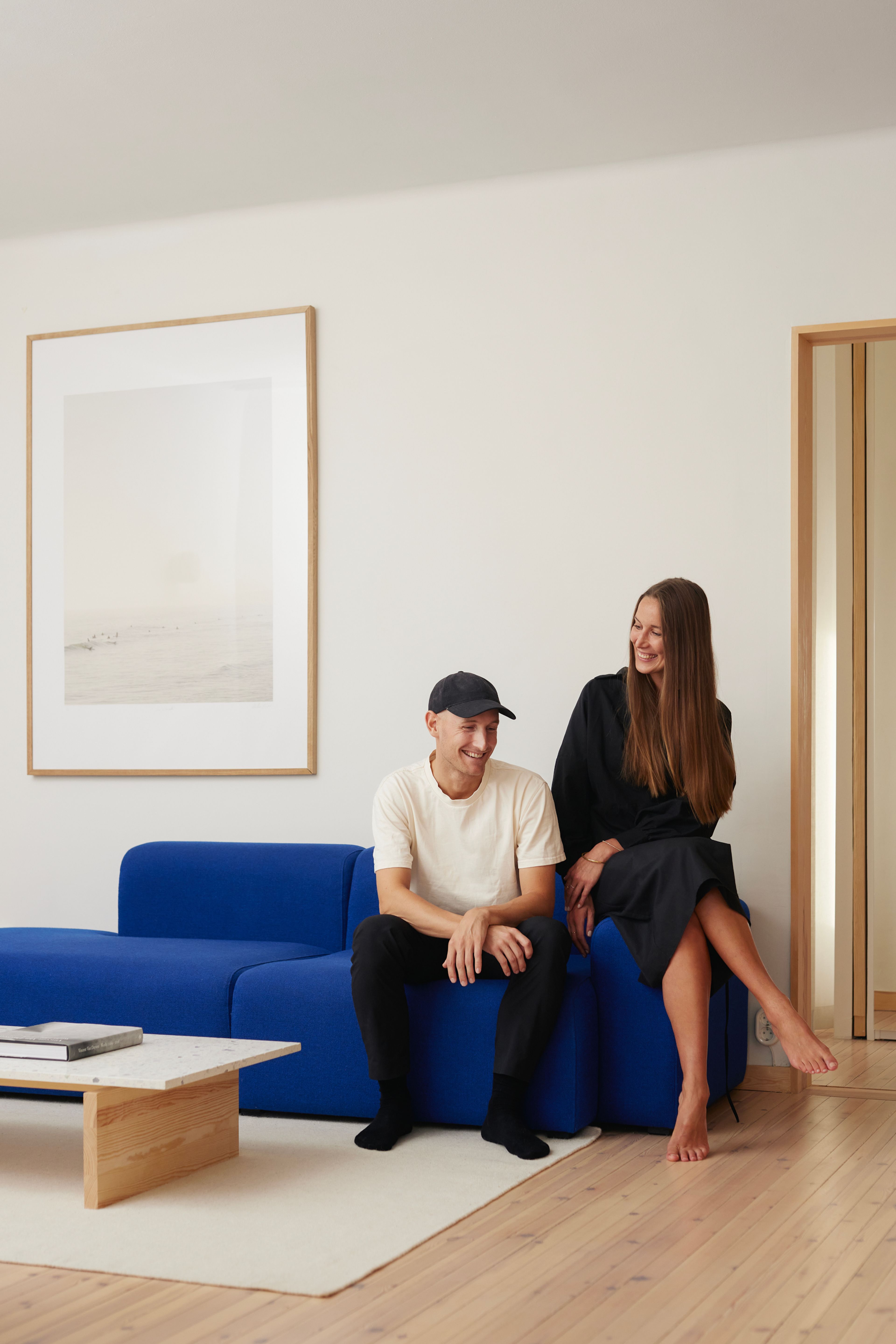 Et kjærestepar sitter i en blå sofa.