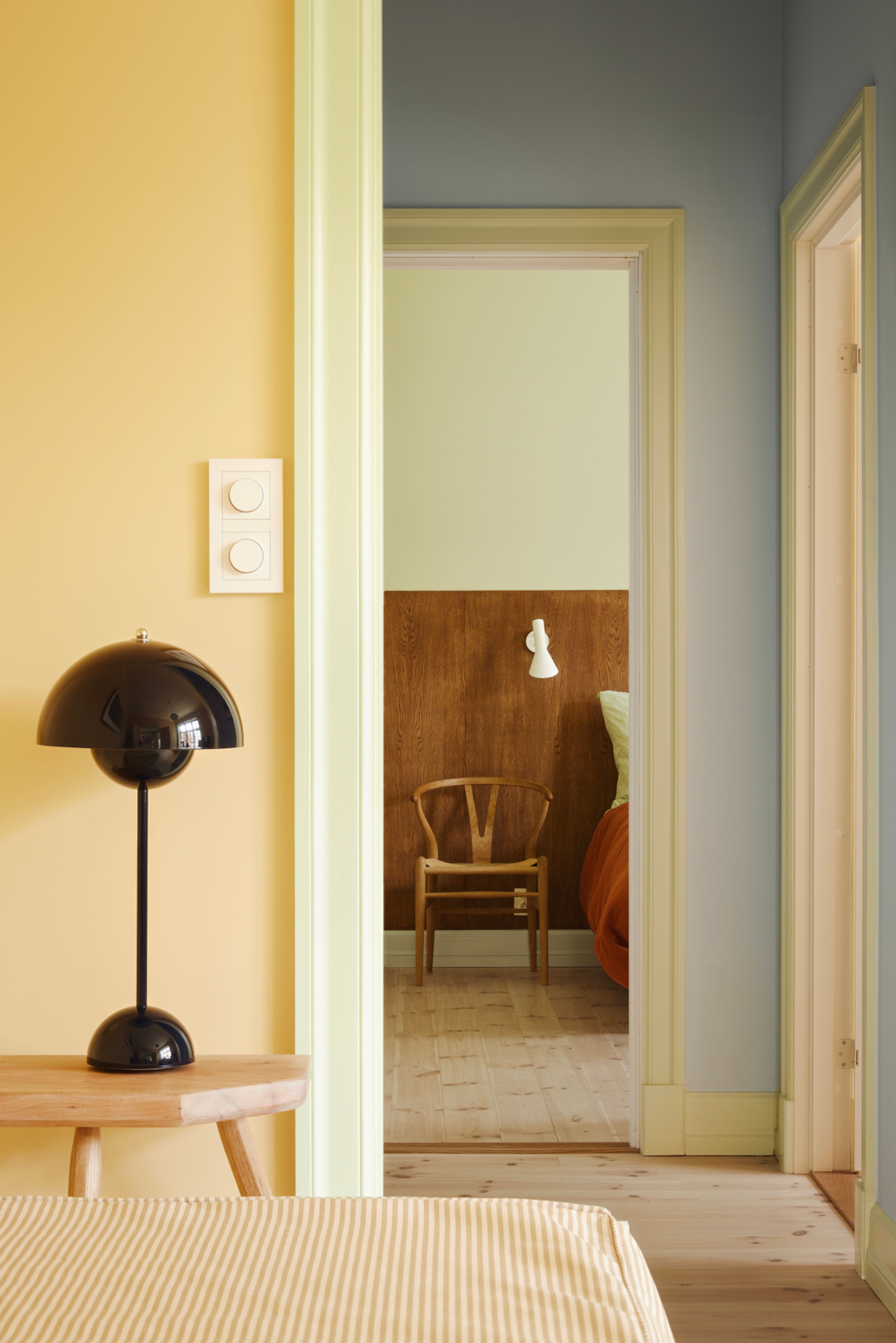 Fra det ene soverommet ser man at det er ulike farger på veggene. Gult på soverommene og blått i gangen.