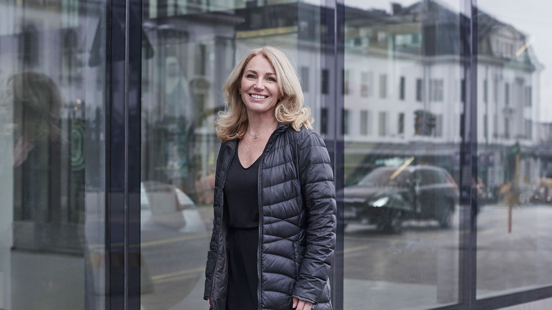 glad kvinna i svart jacka