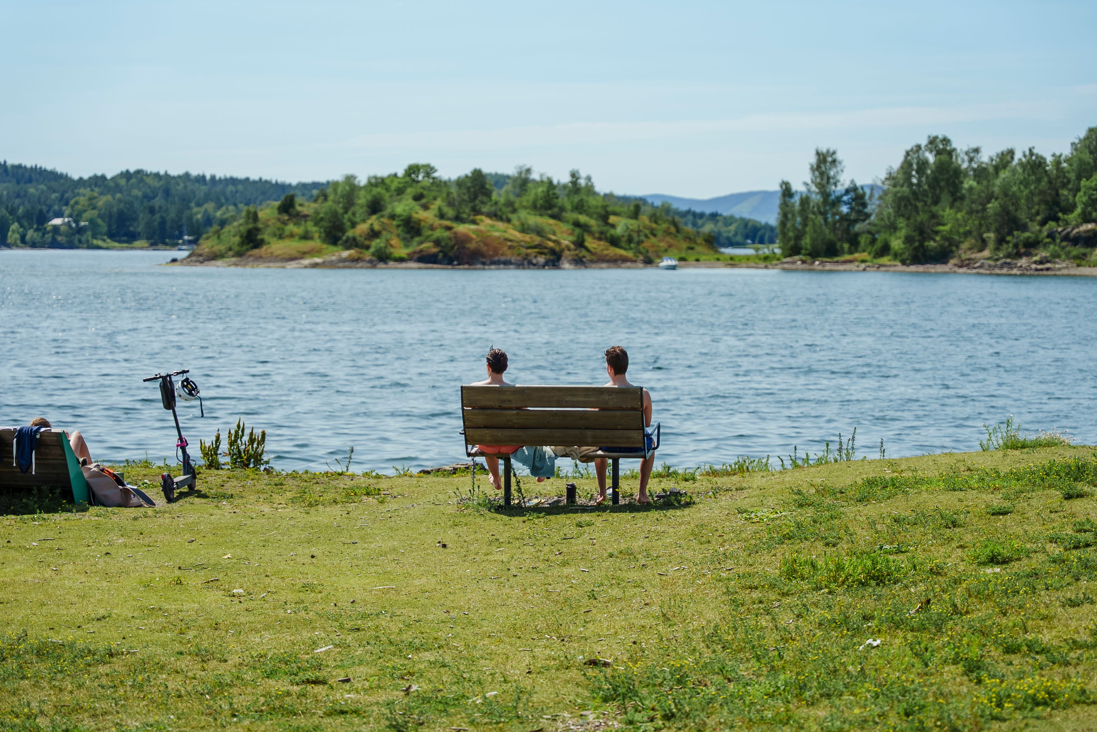 Bilde av benk med to personer ytterst på Storøyodden.