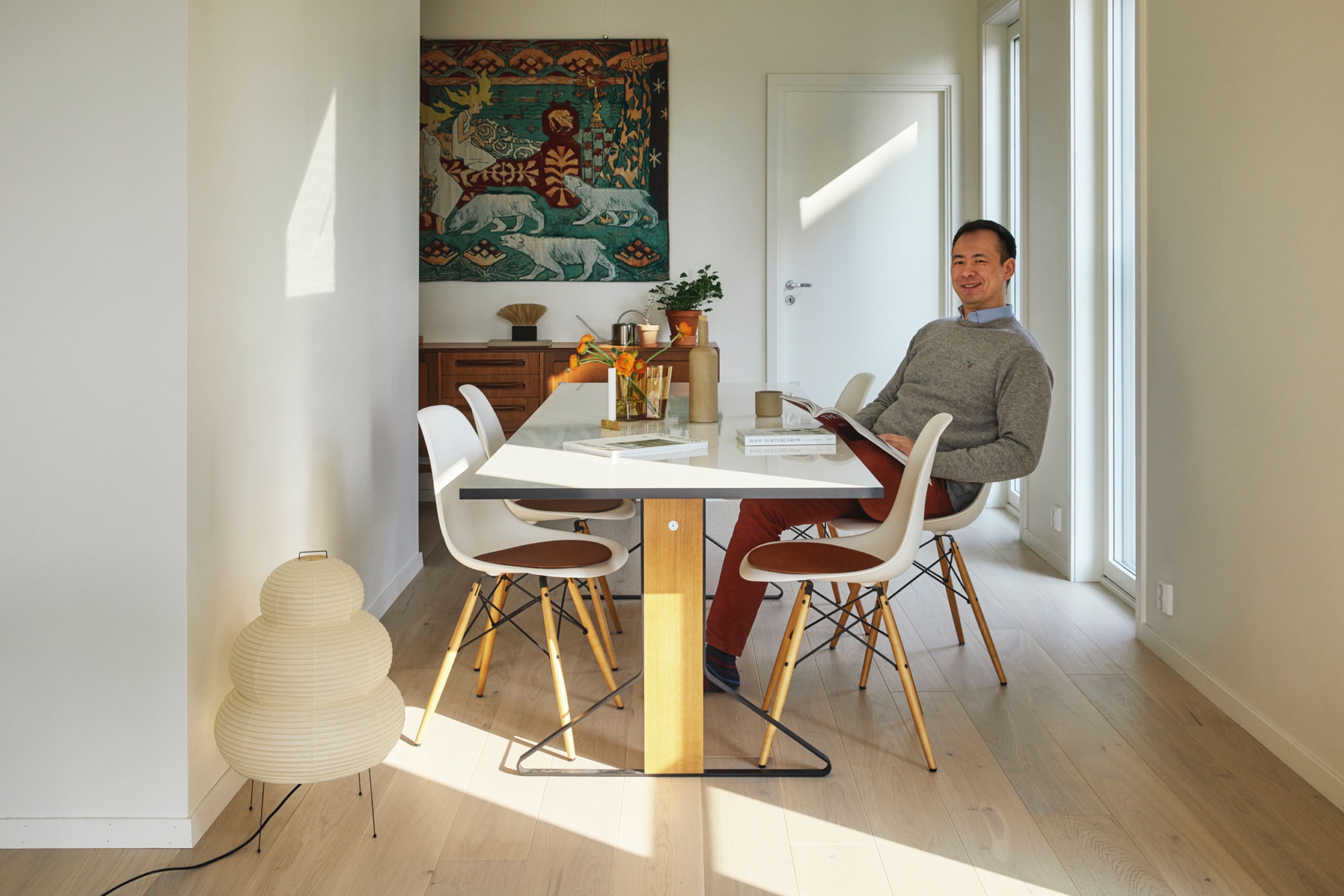 Foto av Vincent Tsang i spisestuen i sin nye bolig i Kikut