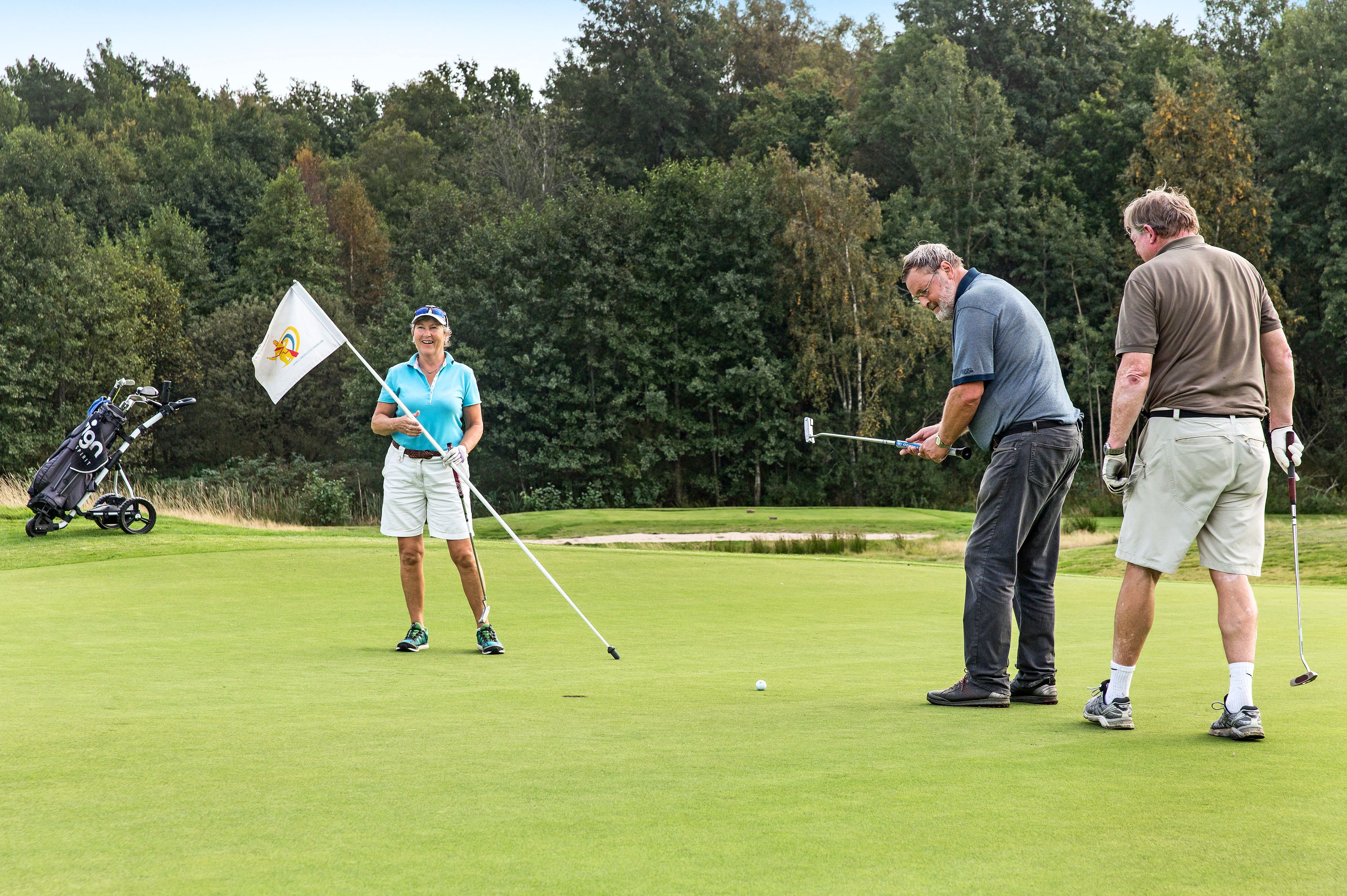 Tre ivrige golfspillere i sving på Gamle Fredrikstad Golfklubb.