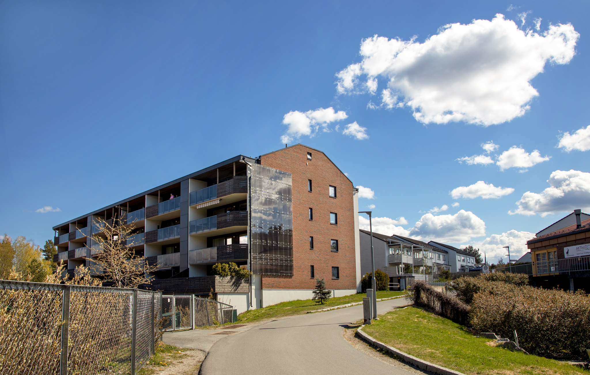 Bilde av fasaden til en boligblokk med solceller på utsiden.