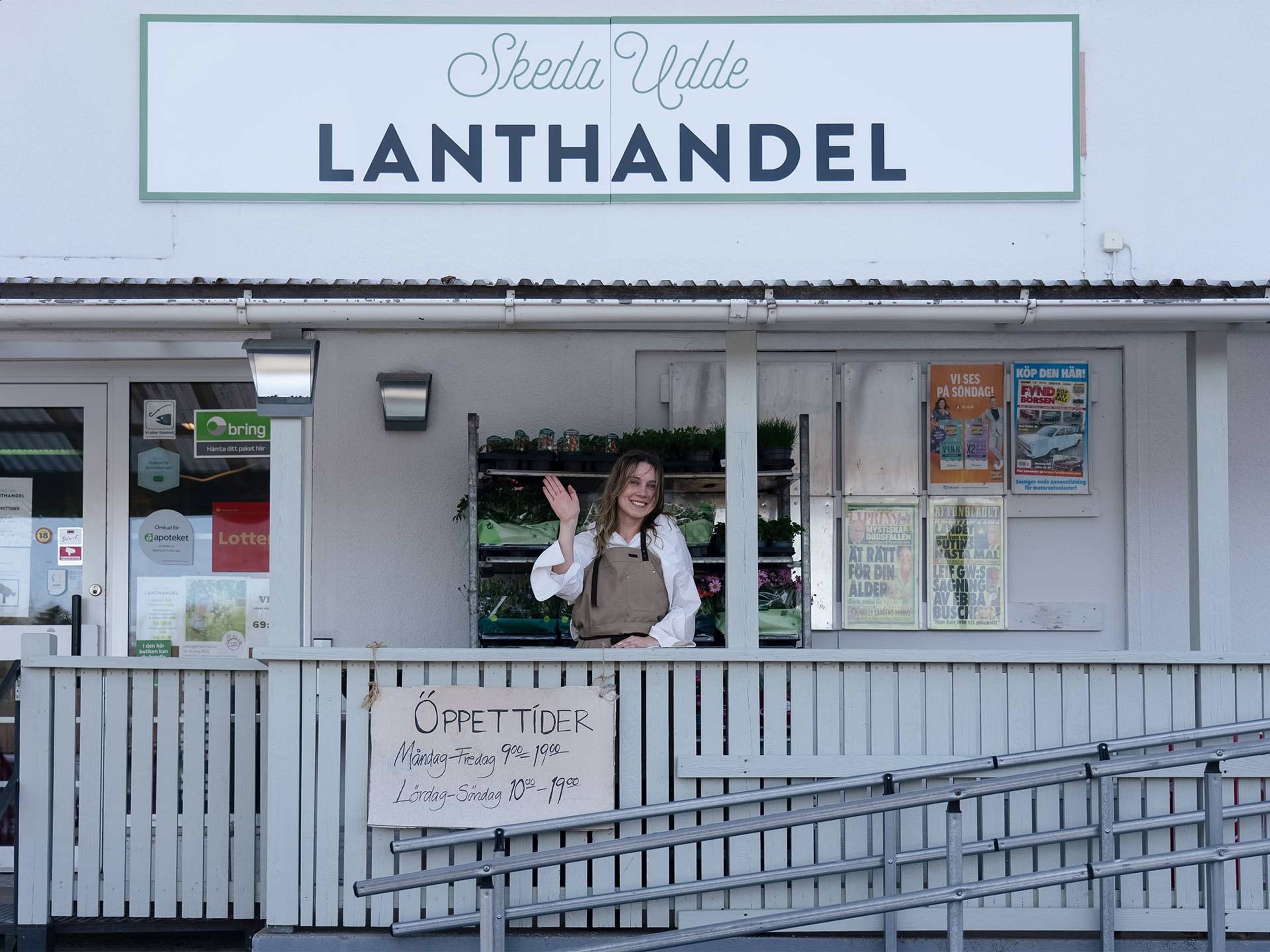 Foto på Skeda Udde lanthandel med person som vinkar från verandan