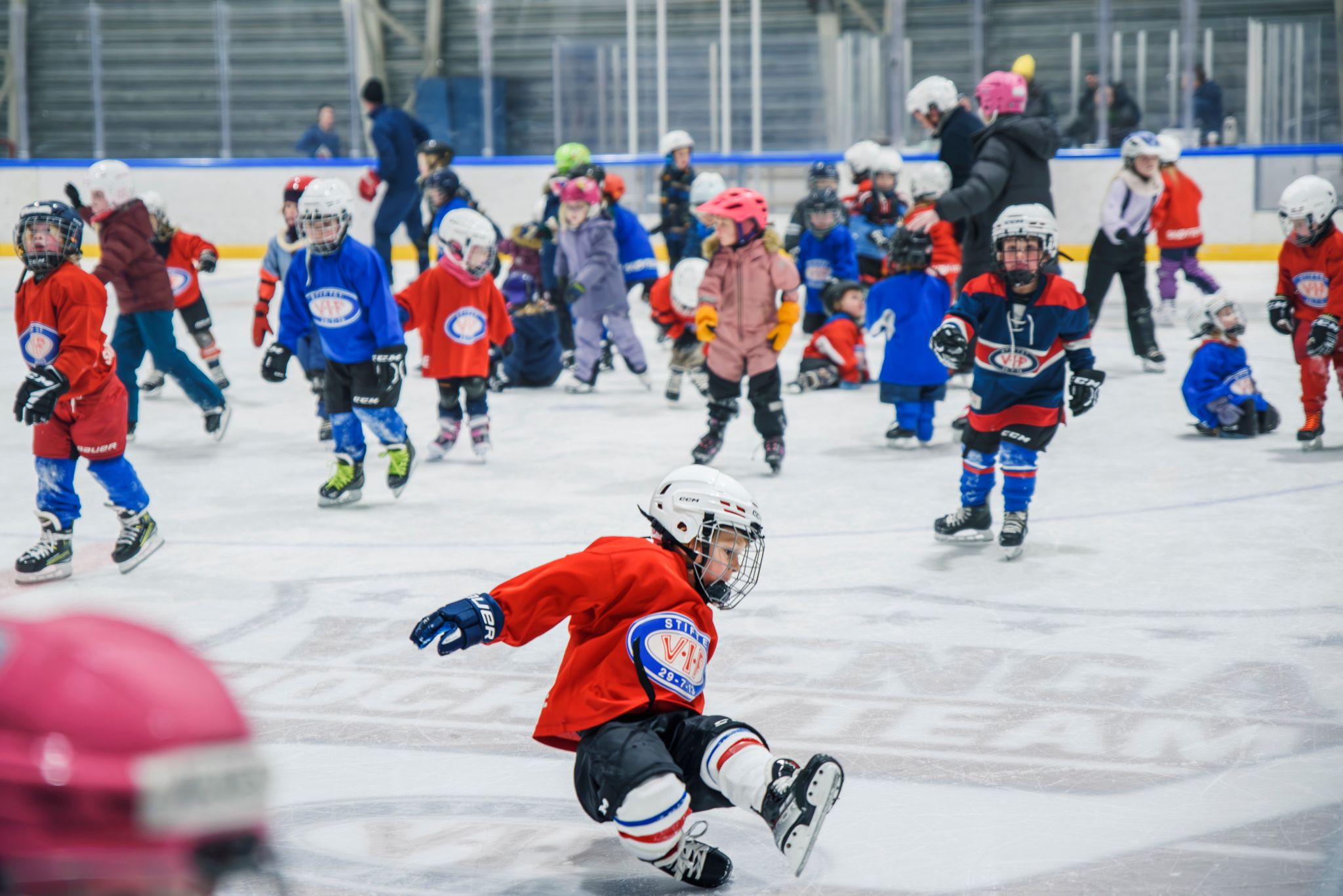Foto av mange barn som står på skøyter.