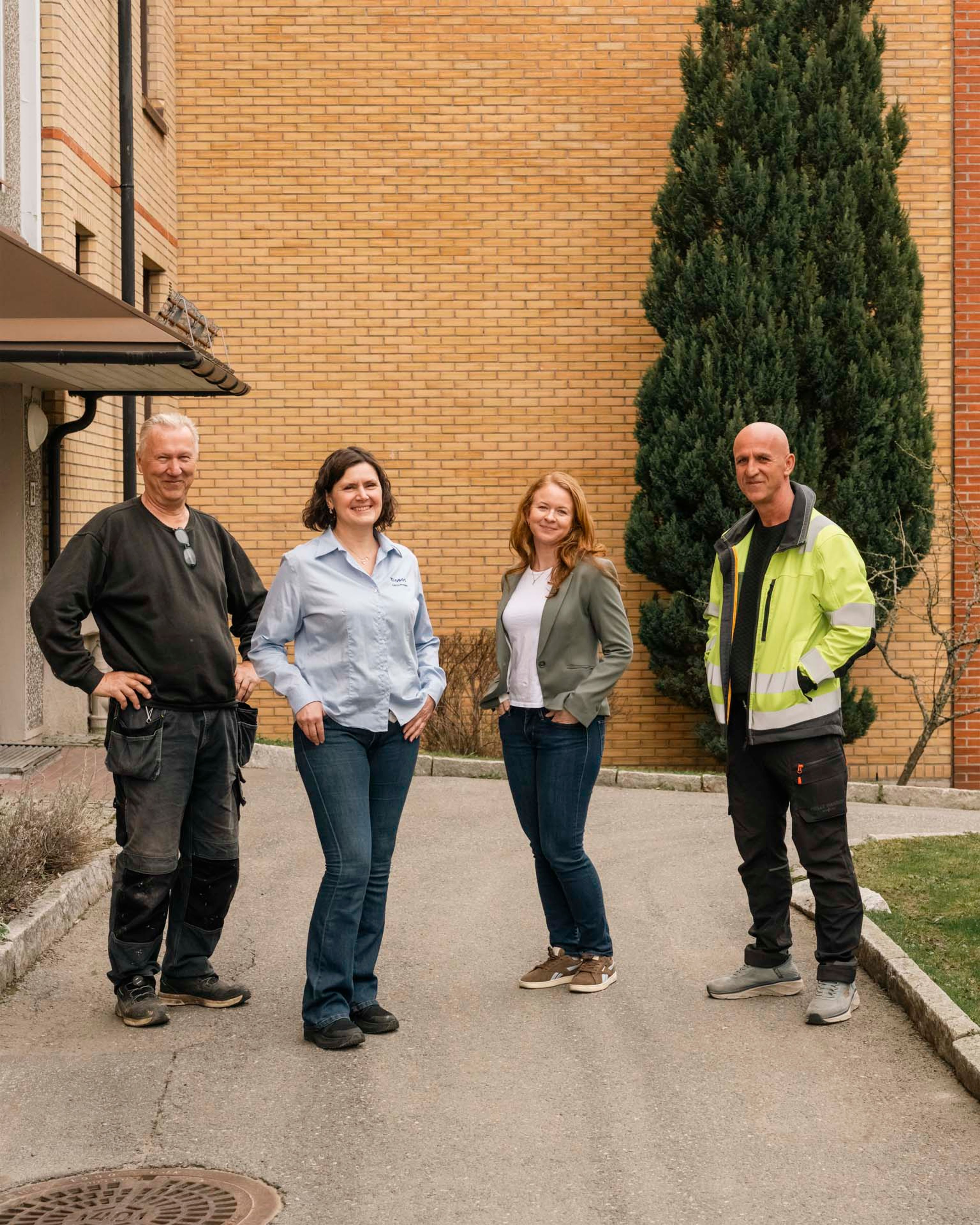 Tor Arne Adamsen, Monika Skarphagen, Cathrine Karlsen og Ilirjan Rrustemaj står foran en gul murfasade.