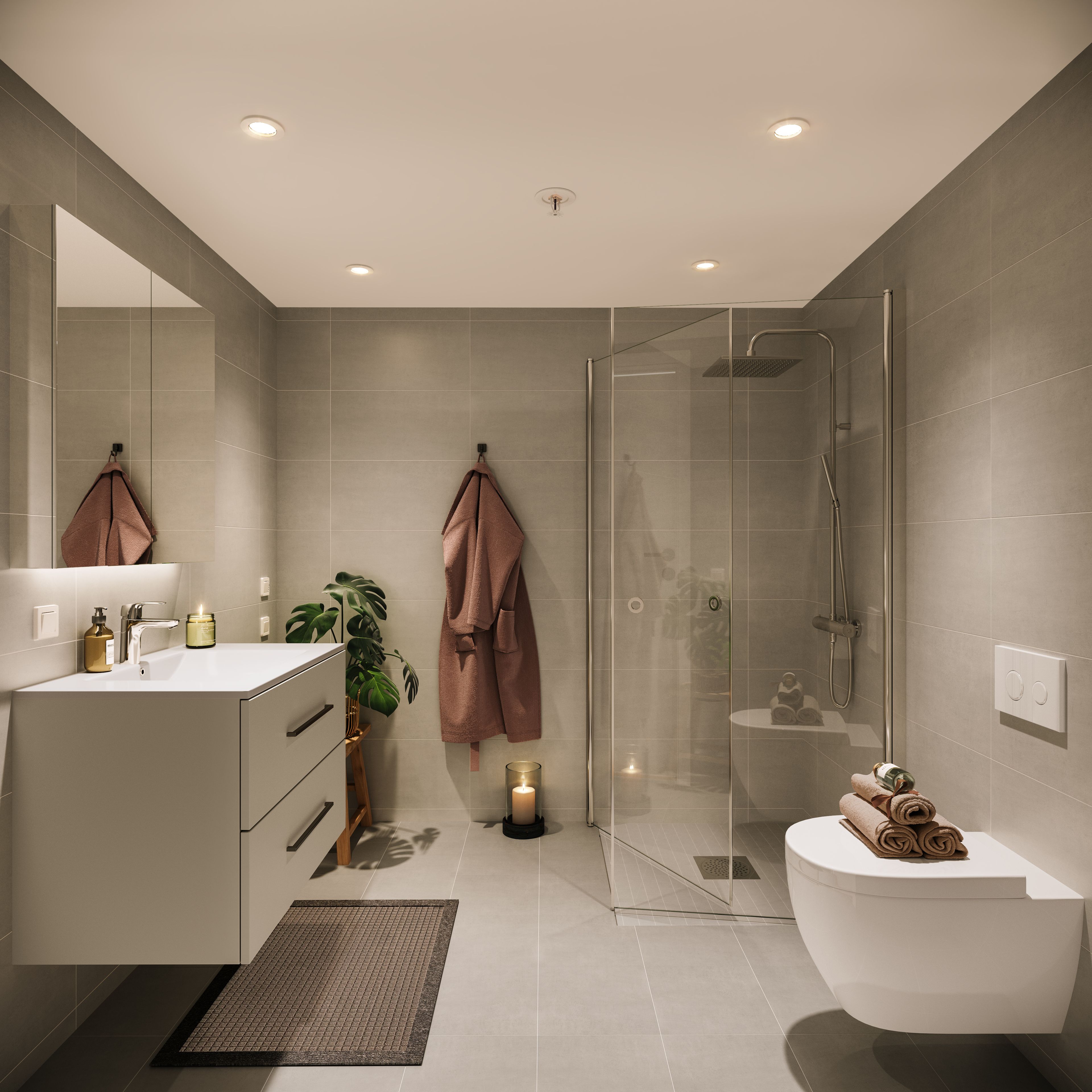 Et bad med beige fliser og beige servant i Ladebyhagen.