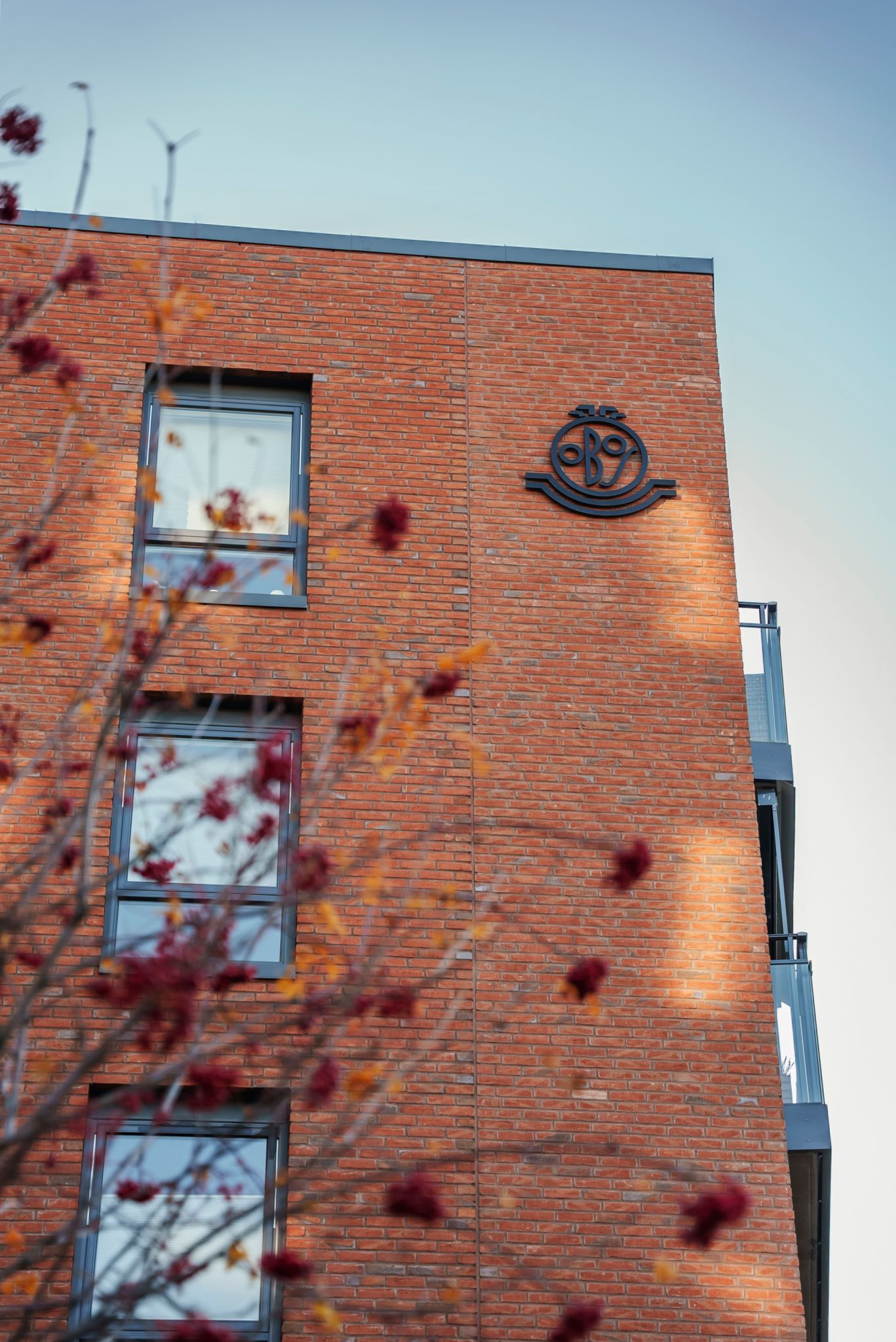 Bilde av et rød mursteinsbygg og OBOS-logoen på