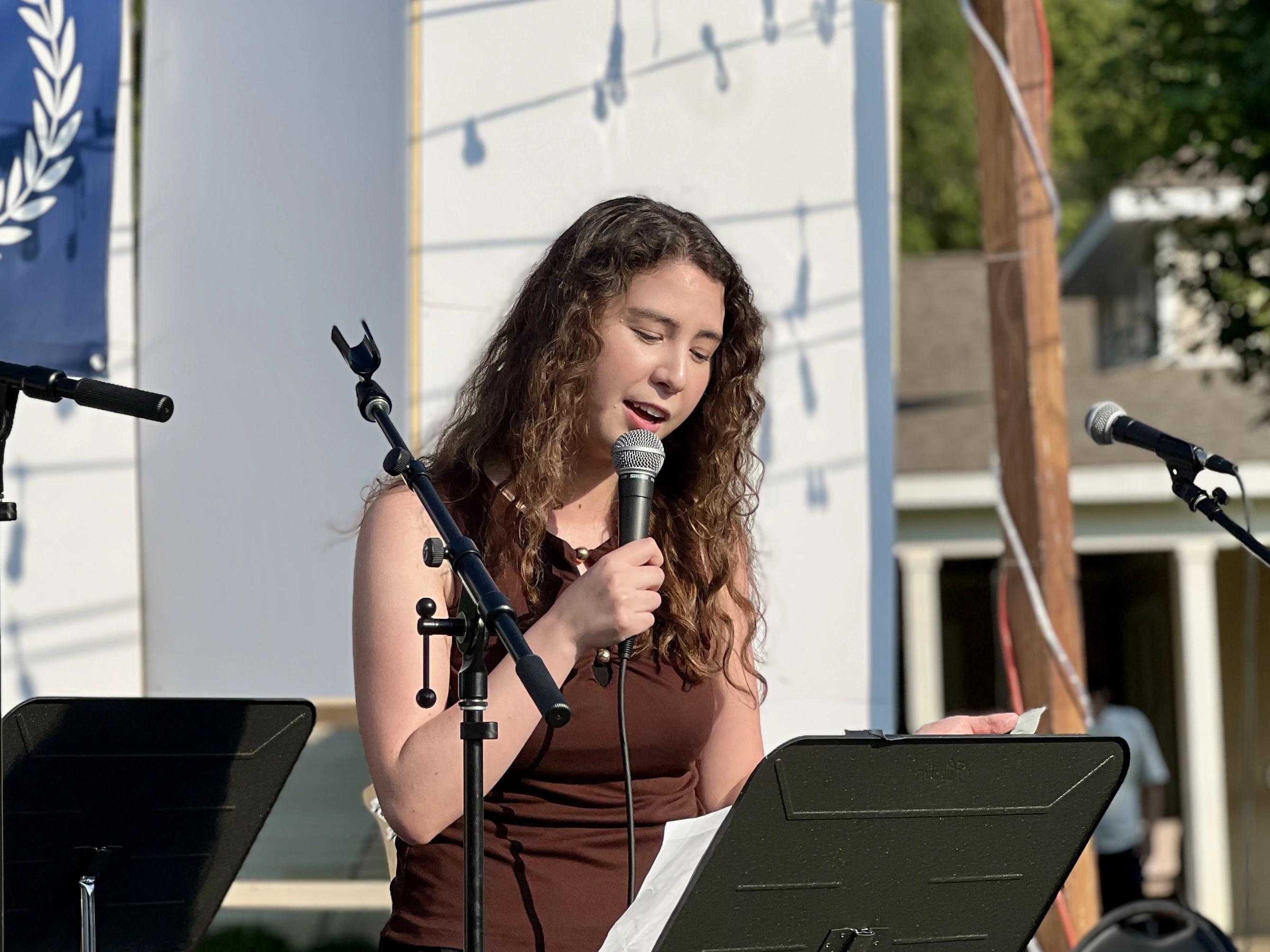 Rebecca singing on stage