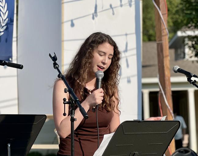 Rebecca singing on stage