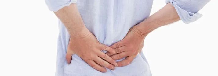 Person holding their lower back with both hands