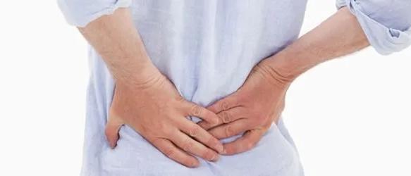 Person holding their lower back with both hands