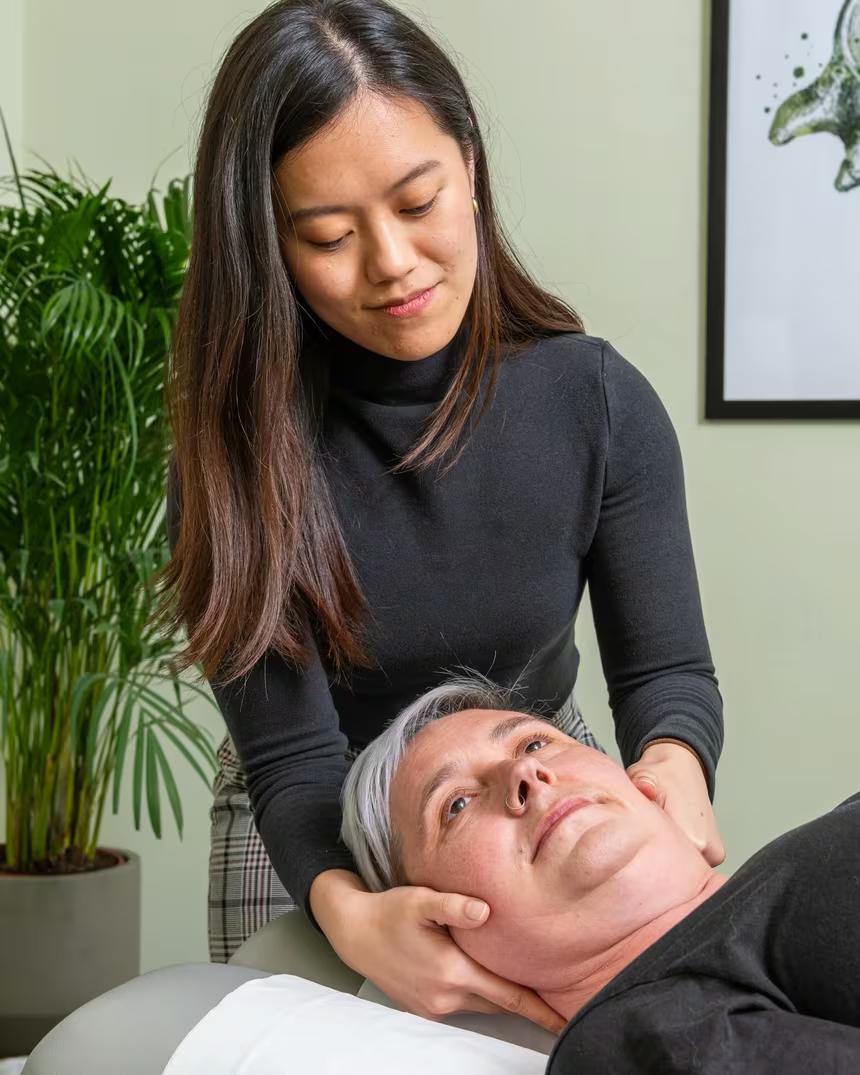 A chiropractor working on a patient in one of our treatment rooms