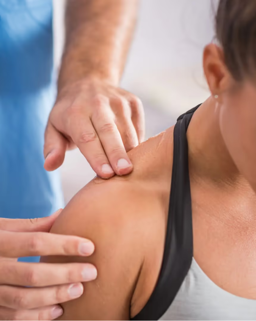 A physiotherapist treating a patient’s shoulder