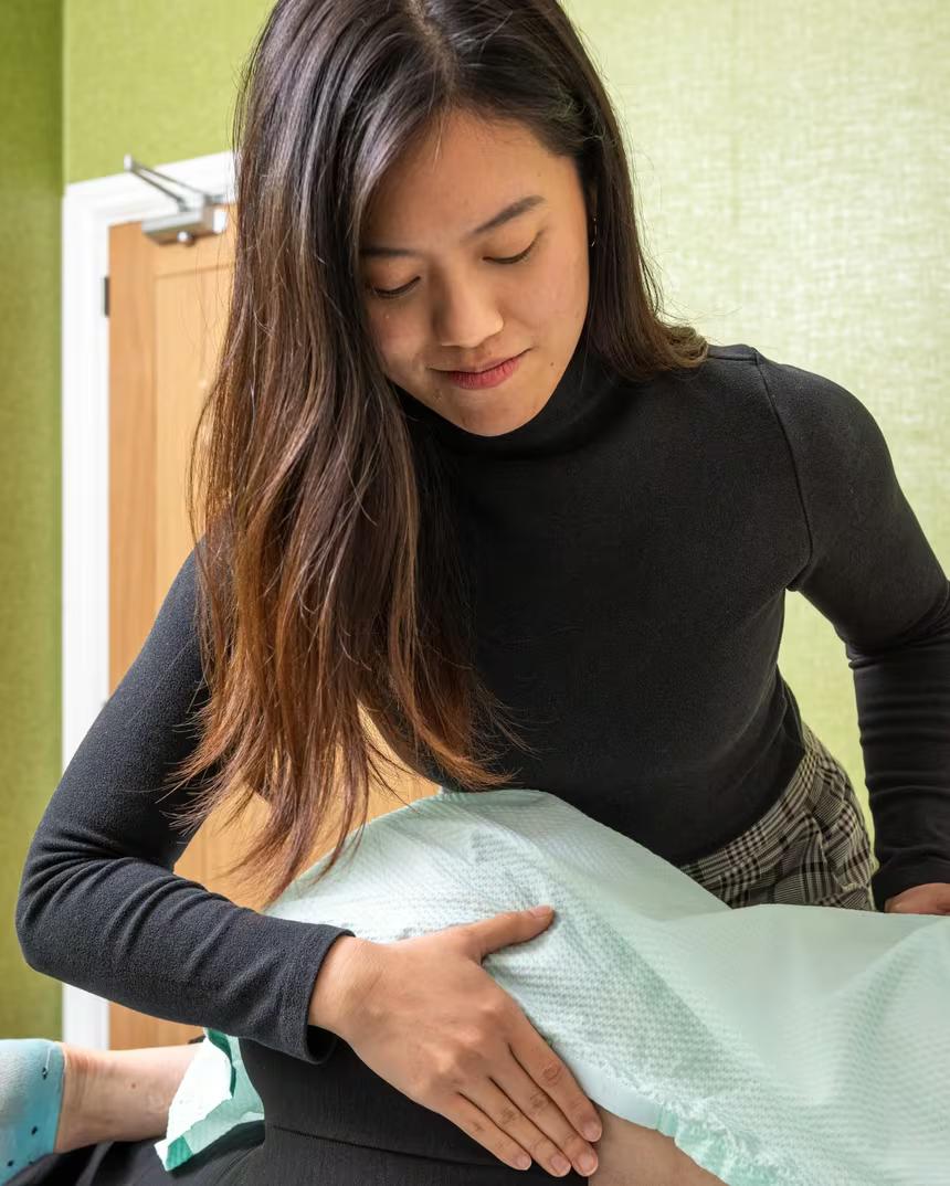 A practitioner working through a patient’s lower back