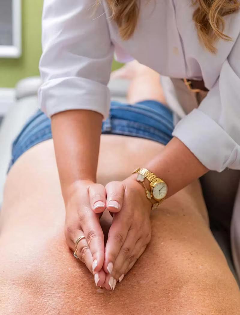 A therapist applying soft tissue massage to a patient