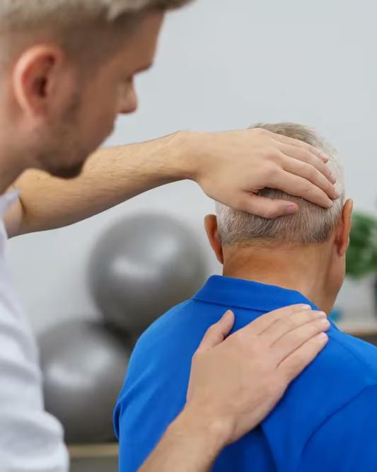 A practitioner examining a patient’s neck and shoulder