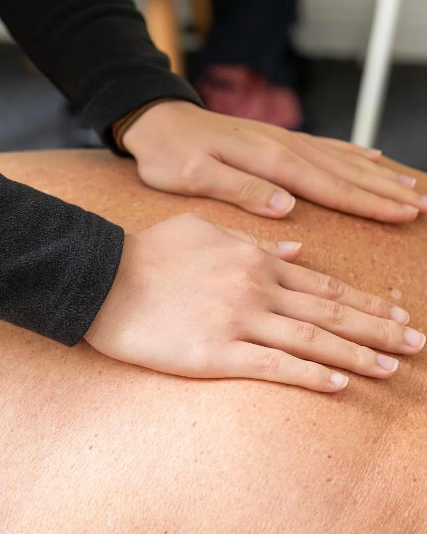 Hands-on soft tissue work across the shoulders