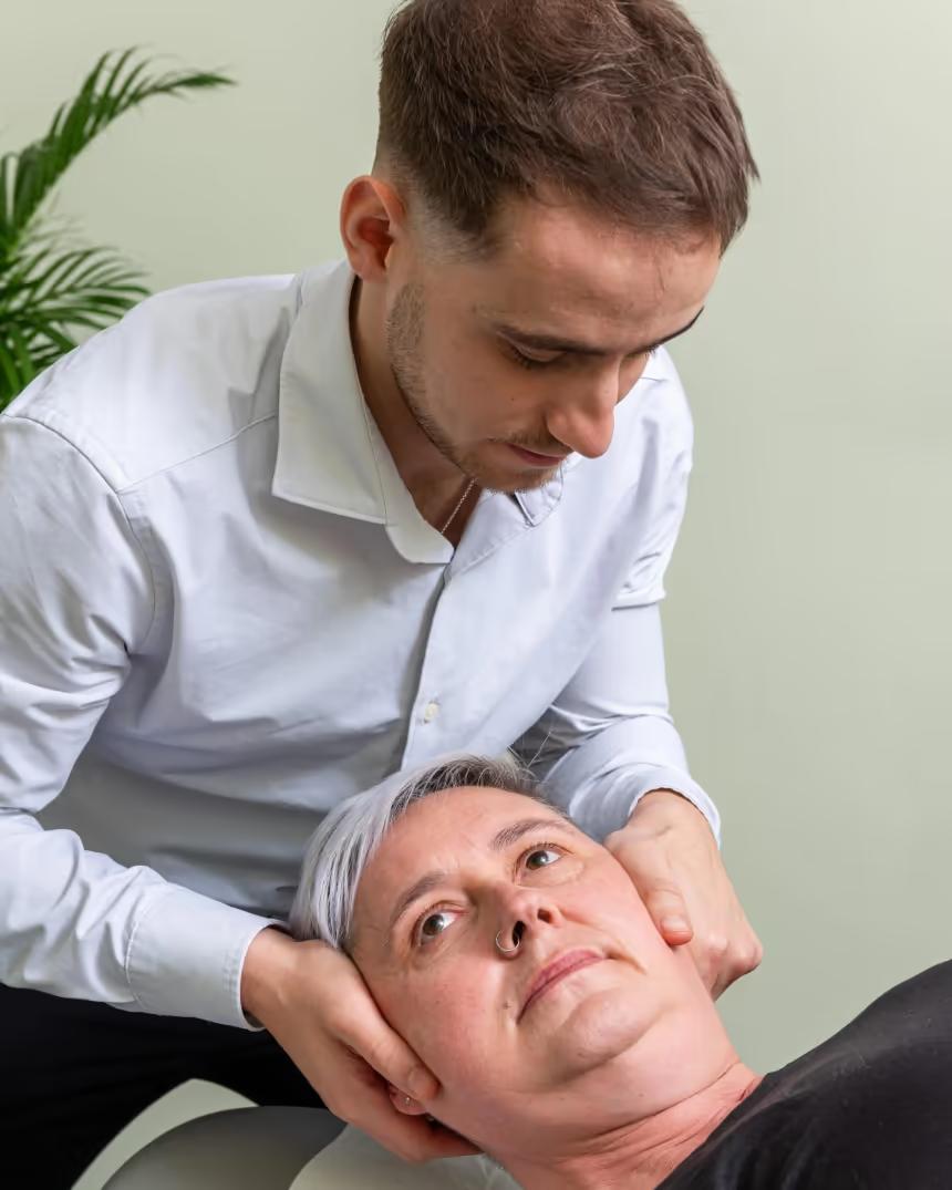 A chiropractor performing a gentle neck adjustment
