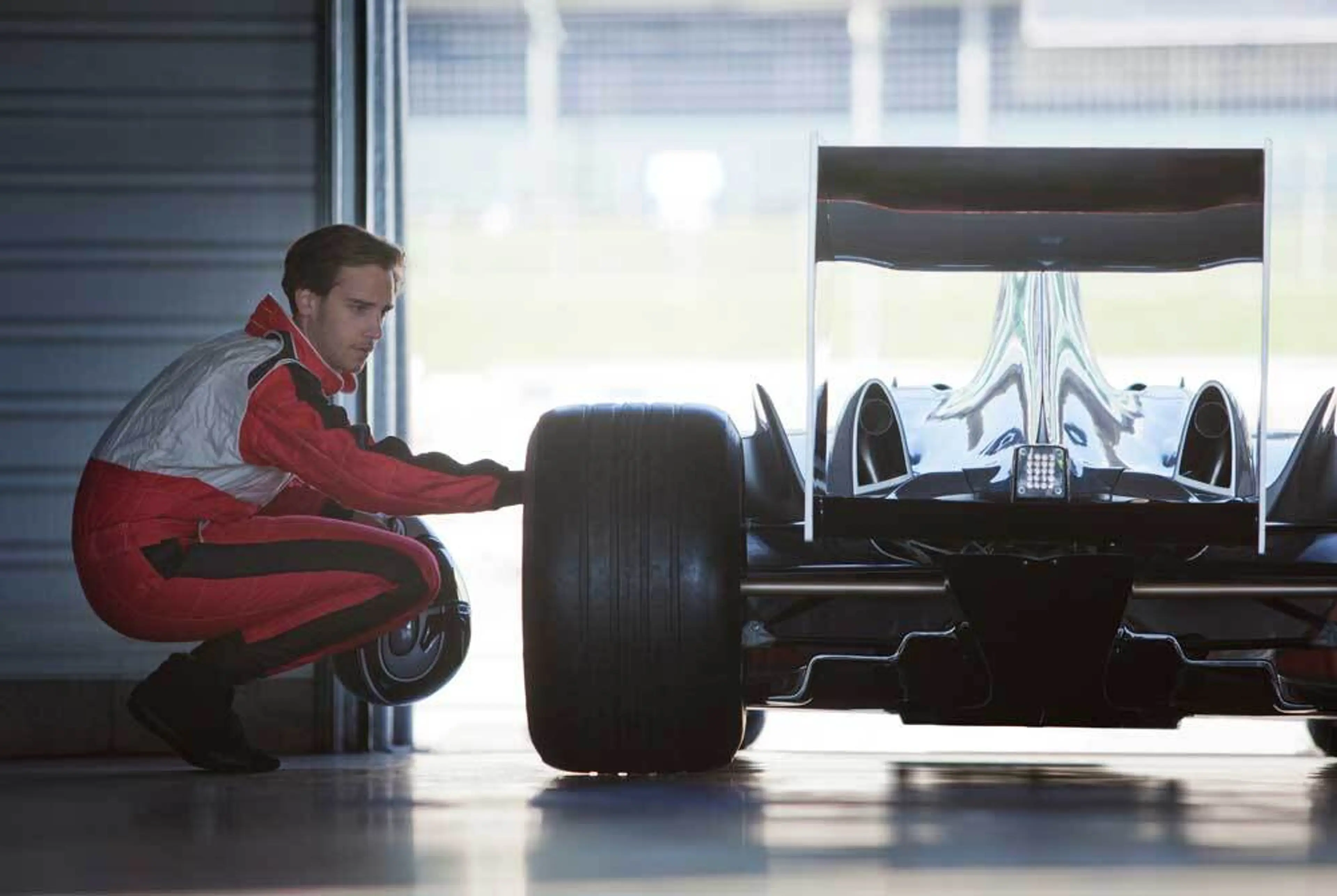 Formula race driver checking his car