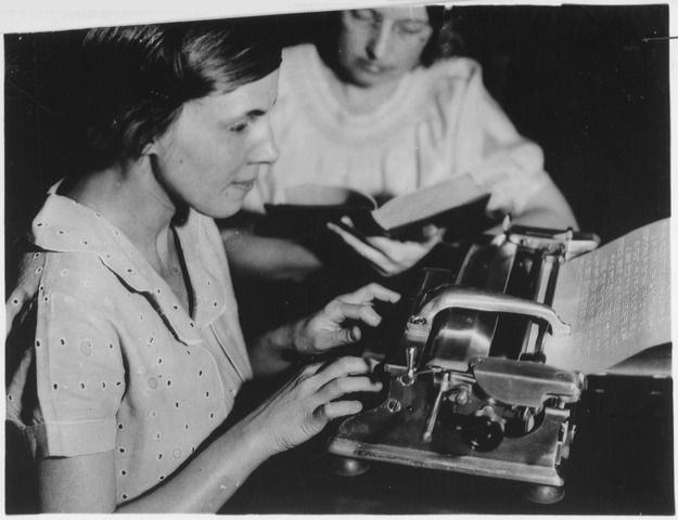 Blind Works Progress Administration (WPA) worker operating braille machine at the Indiana State Library