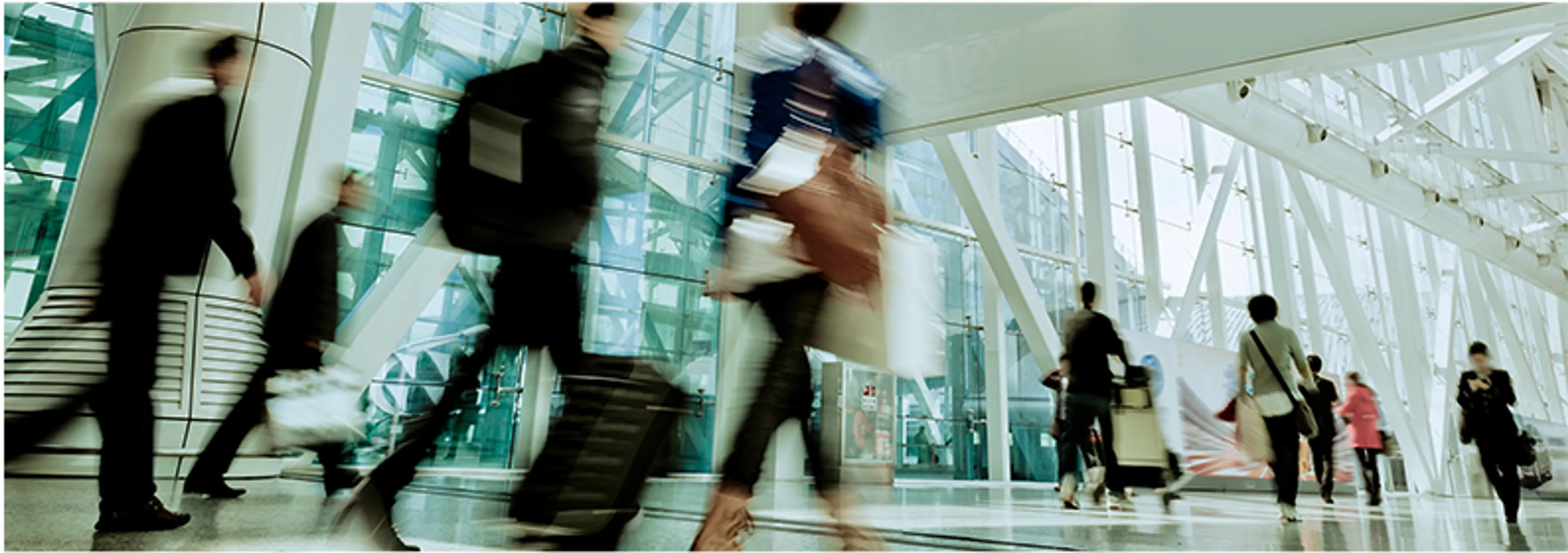 A blurry image of people walking through a building
