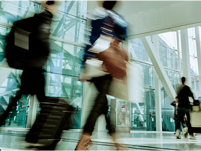 A blurry image of people walking through a building