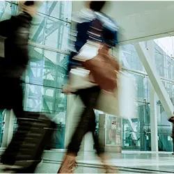 A blurry image of people walking through a building
