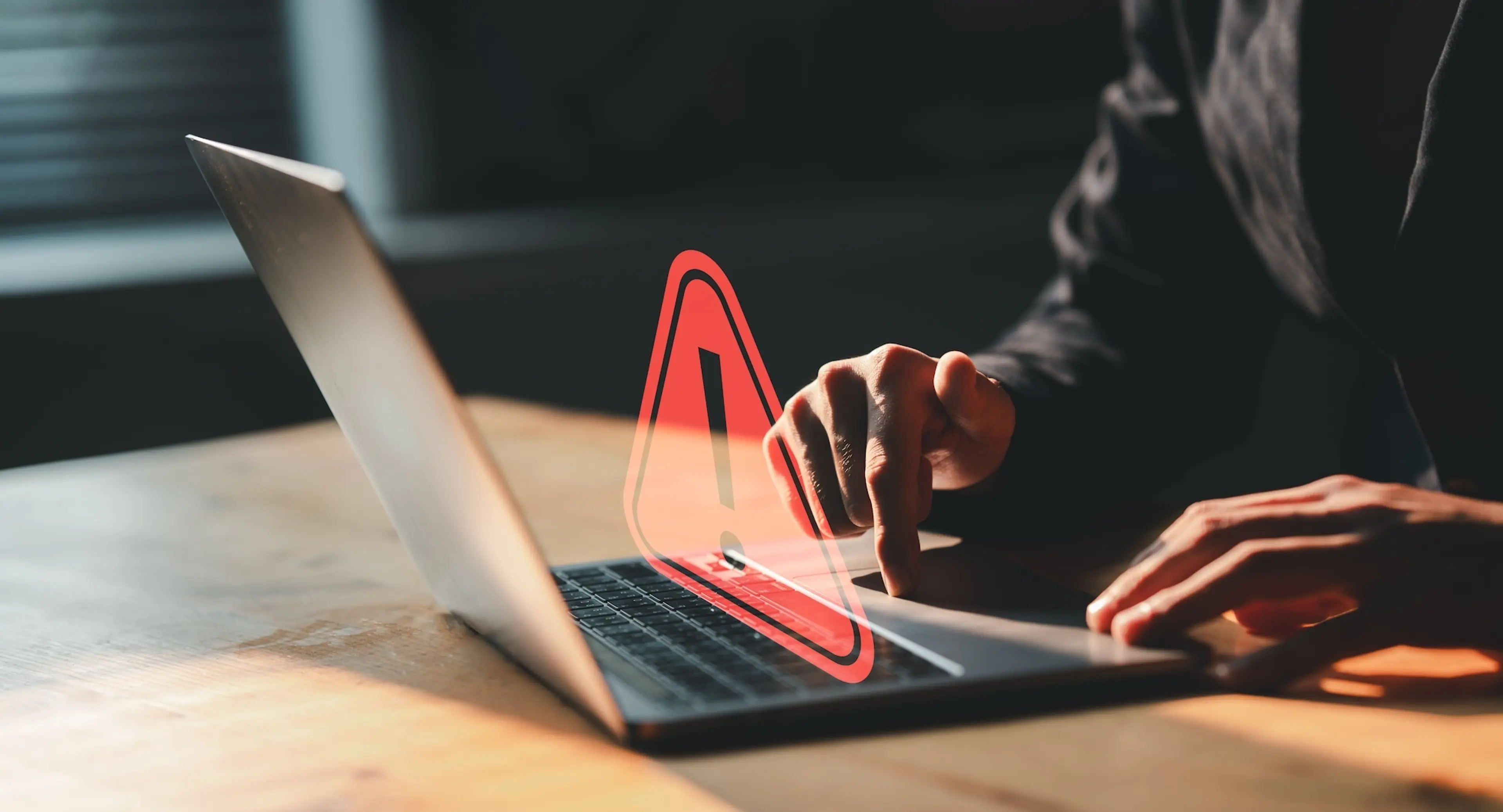A man working on laptop with error sign