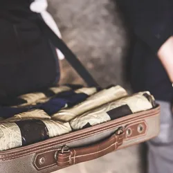 A man with handcuffs and a briefcase full of something