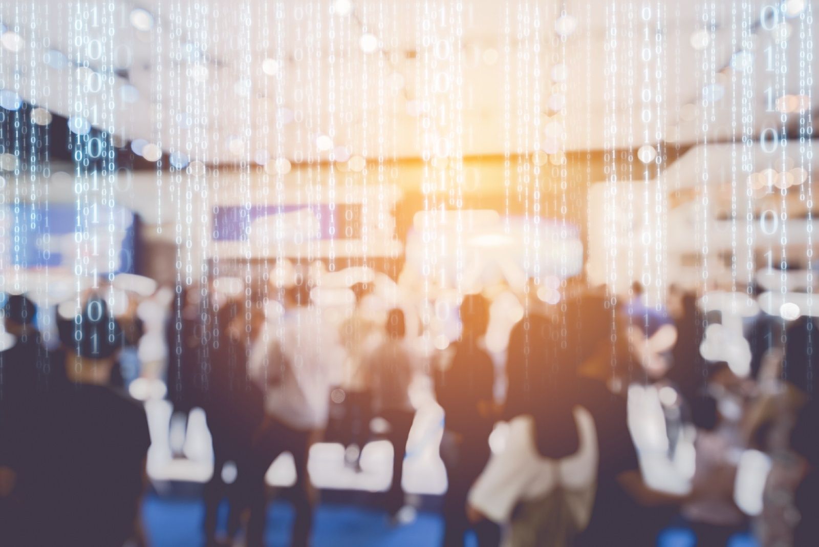 A blurry image of people at a trade show