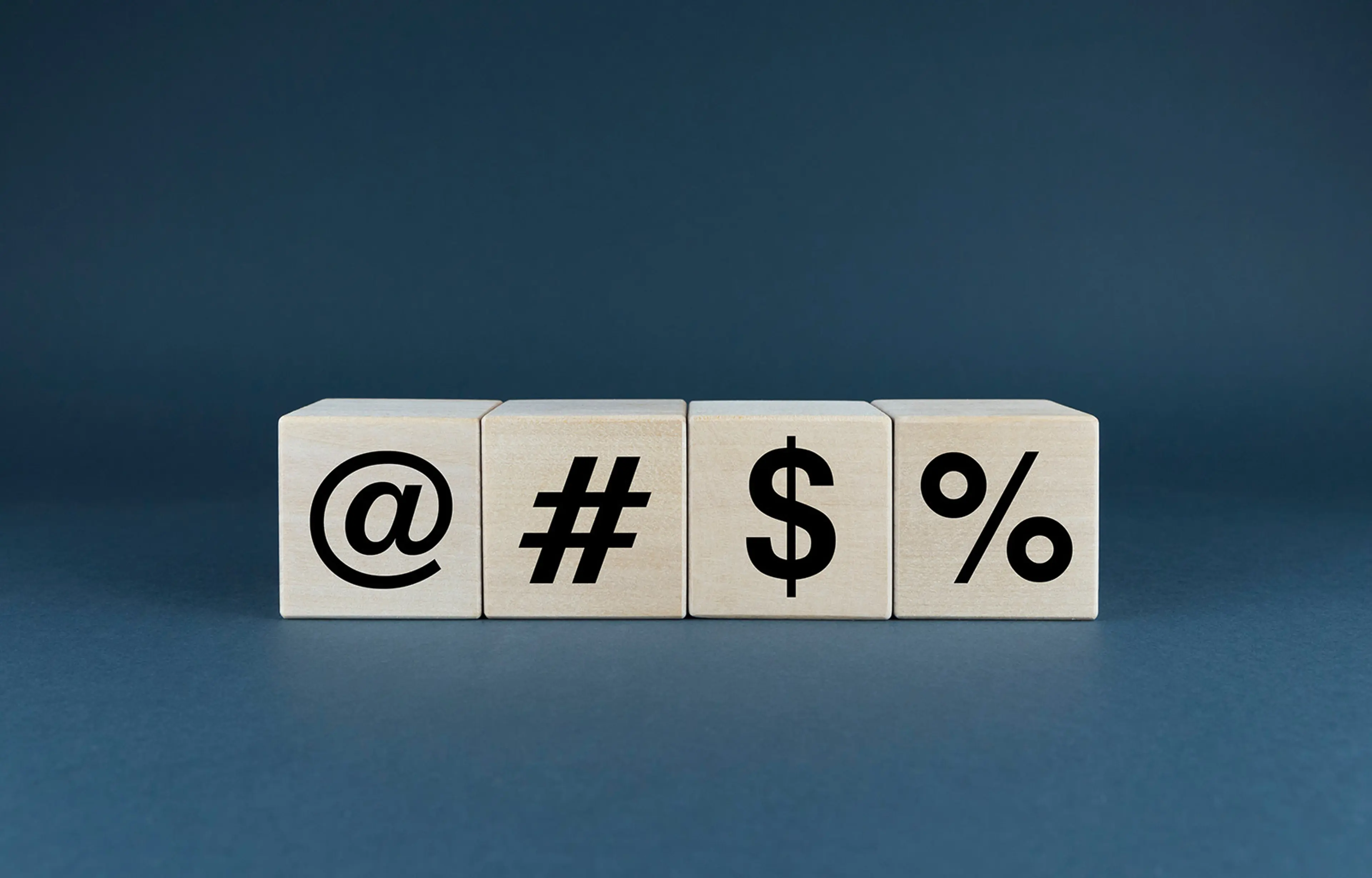 Four wooden blocks showing 4 different special characters