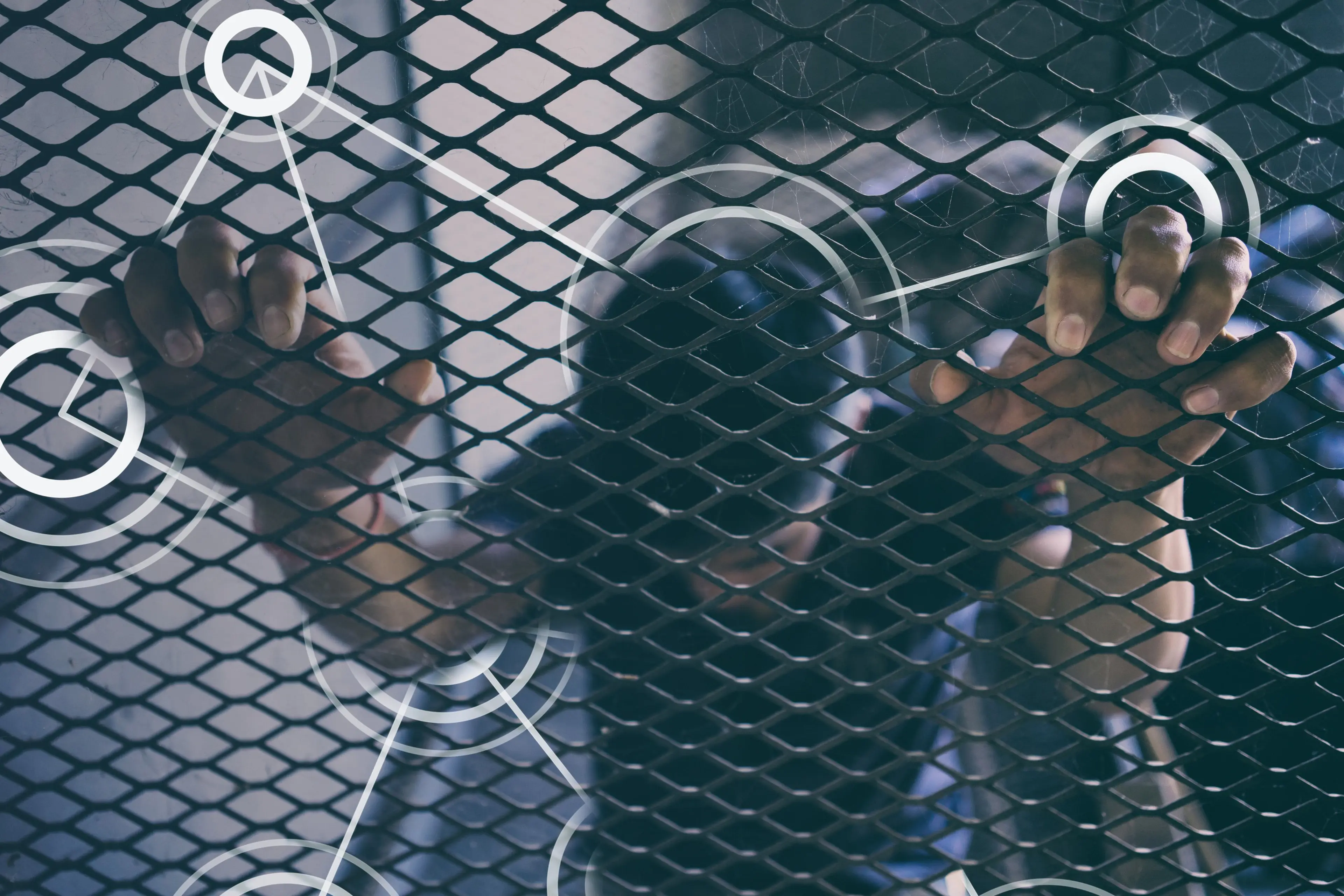 A man behind the iron net while holding the net
