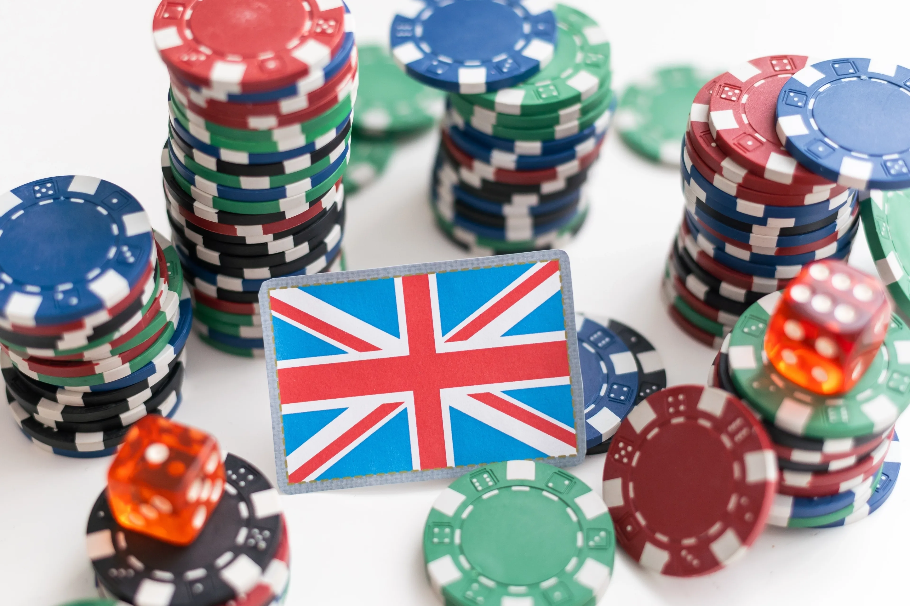 A pile of casino chips and small UK flag placed in centre
