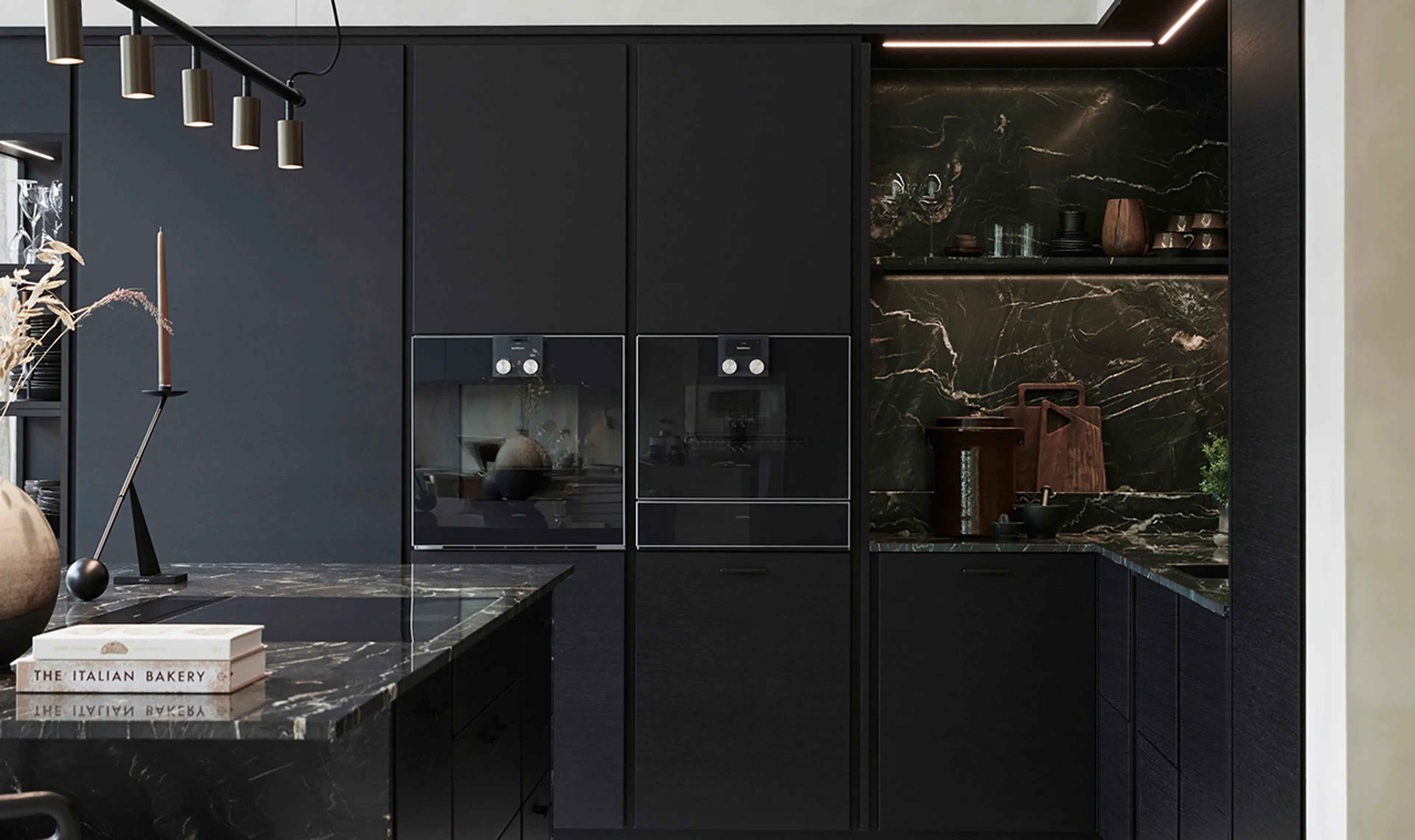 Kjøkken med kjøkkenøy med mørkt steinplate.