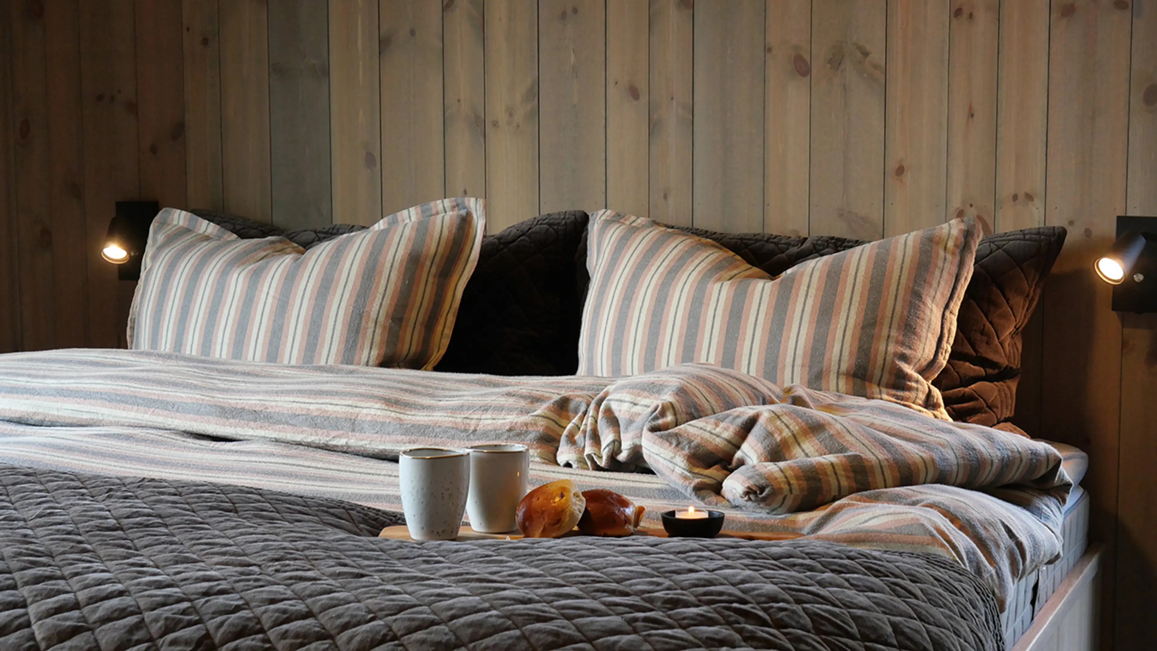 Oppredd seng med furupanel på veggene beiset med interiørbeis Gjøco Lindbergtinden 80004.